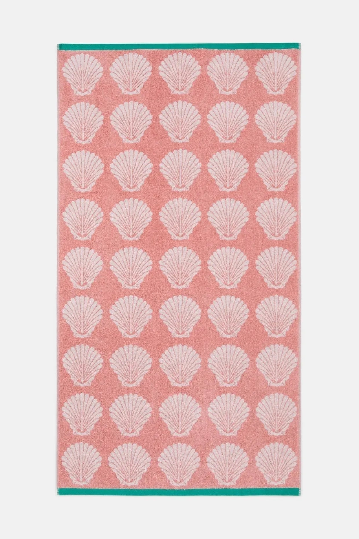 Towel with white shell pattern on a pink background
