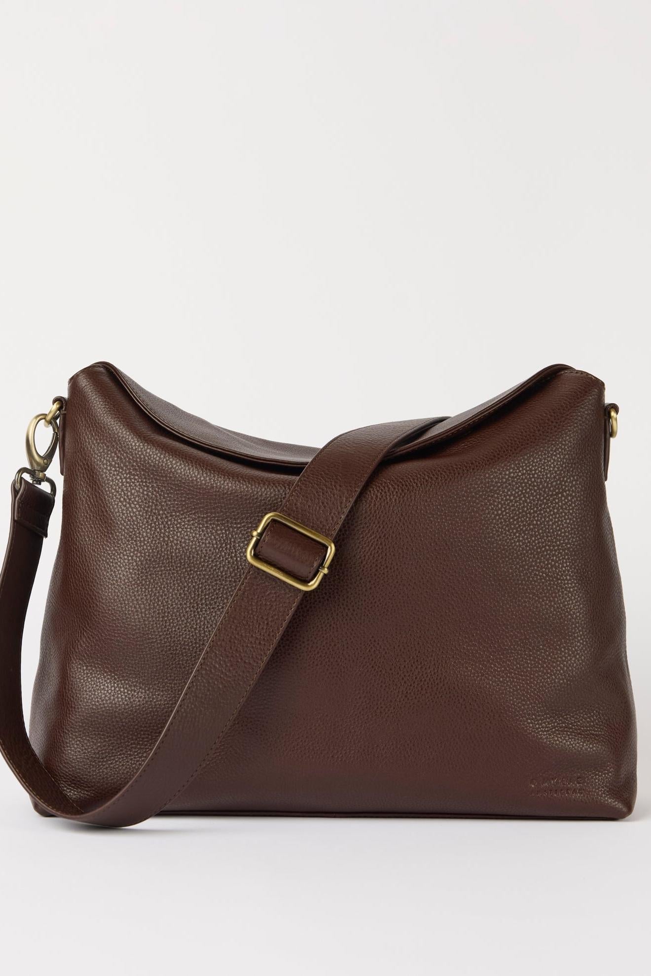 Brown leather handbag with a gold buckle on a white background