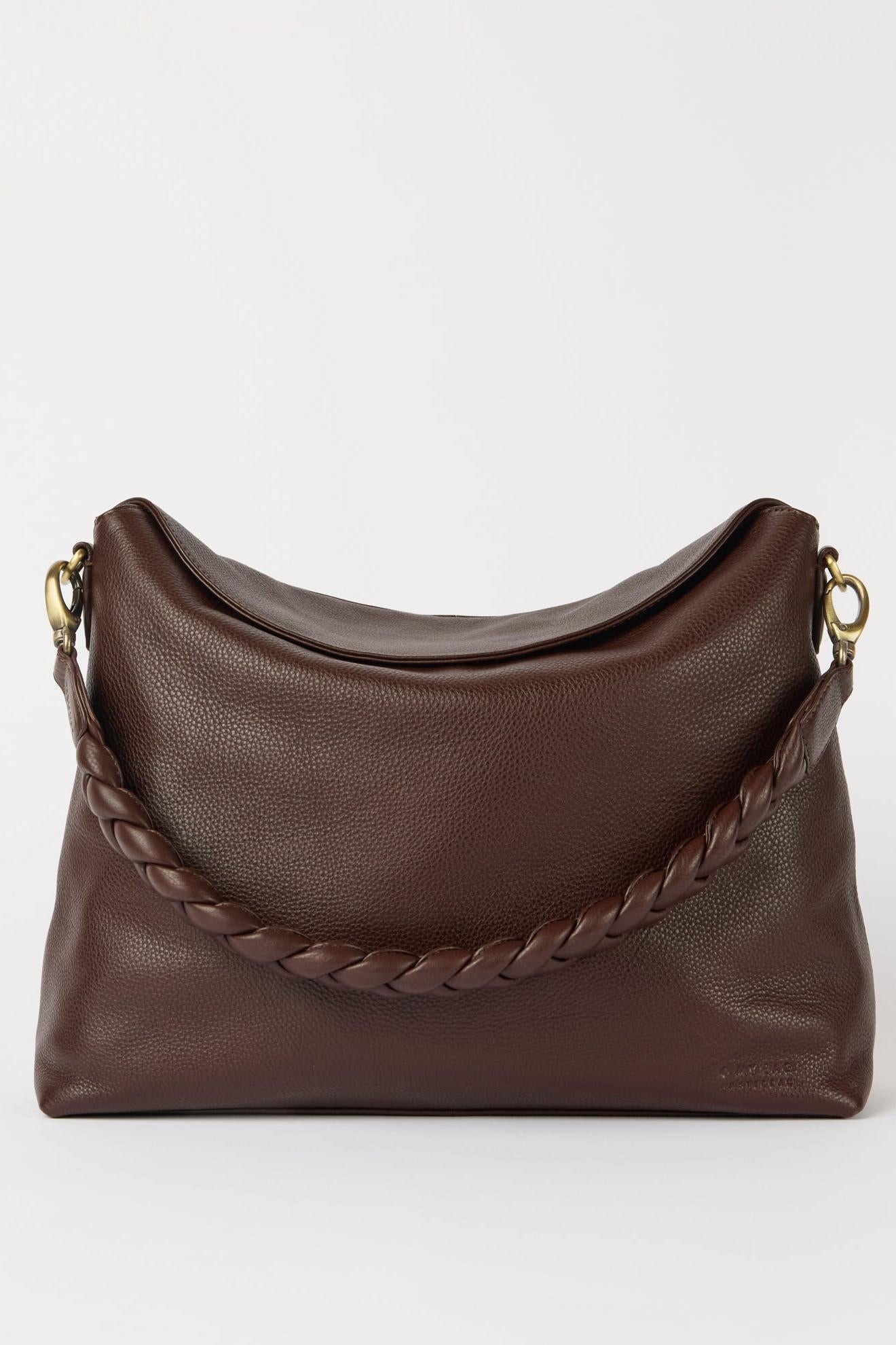 Brown leather handbag with braided handle on a white background