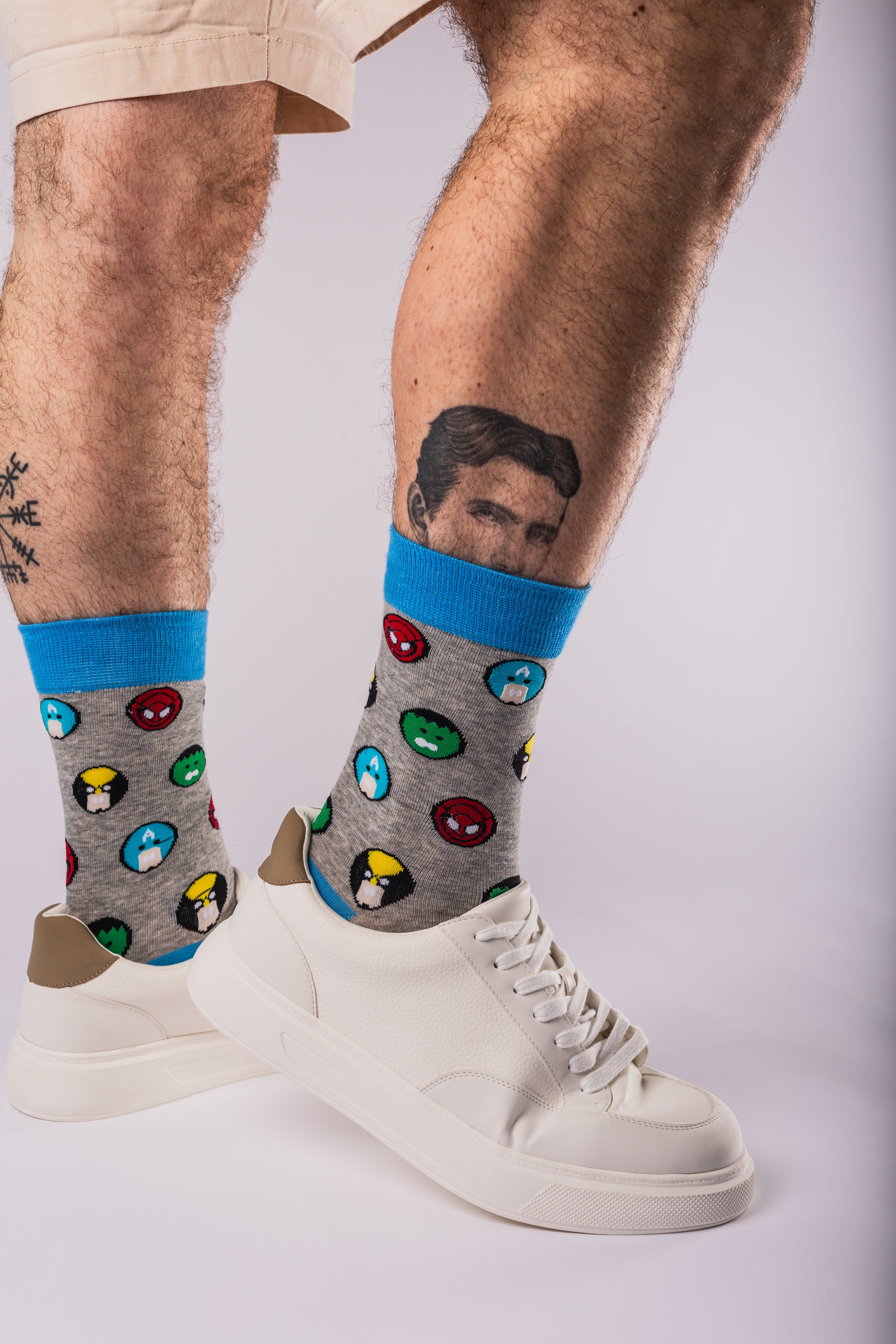 Person wearing colourful socks with cartoon characters on a white background