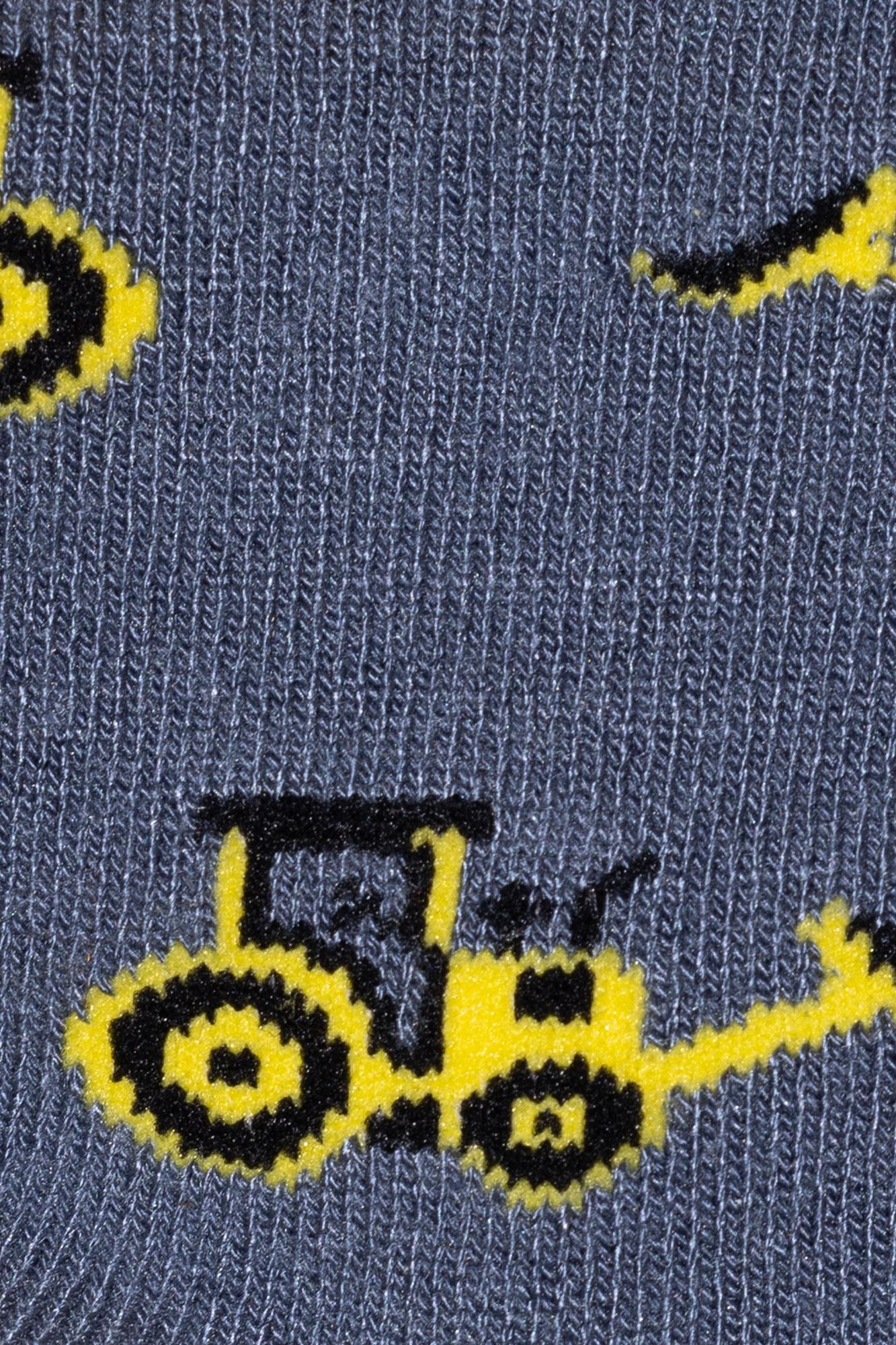 Gray socks with yellow and black tractor designs on a gray background
