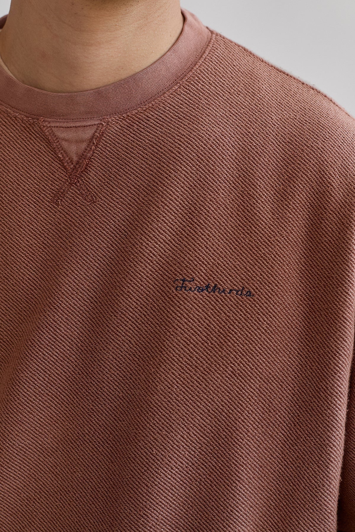 Close-up view of the 'Twothirds' embroidery on the chest of the Fatu Hiva Sweatshirt