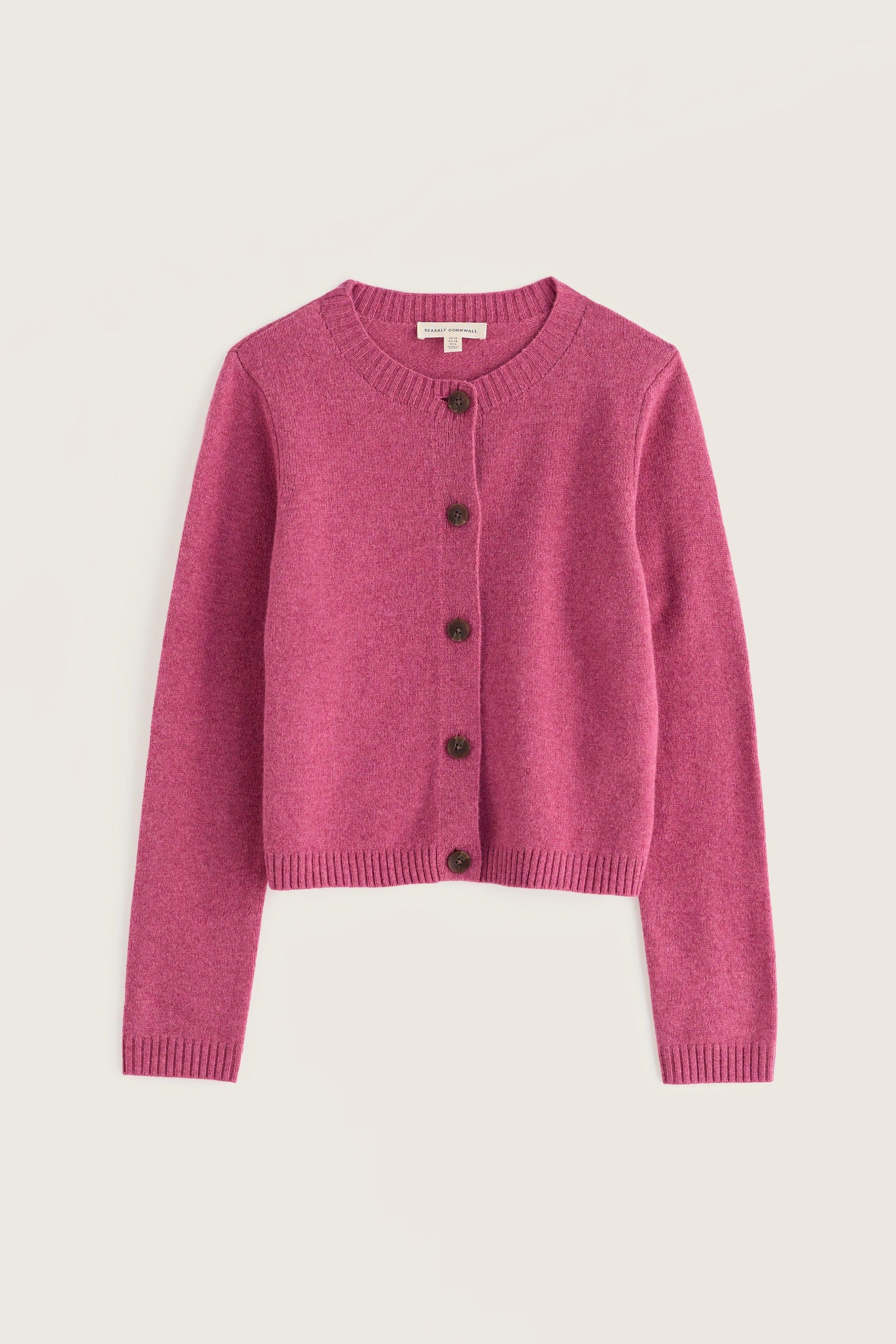 A pink knit cardigan sweater with dark buttons, displayed flat against a light beige background.