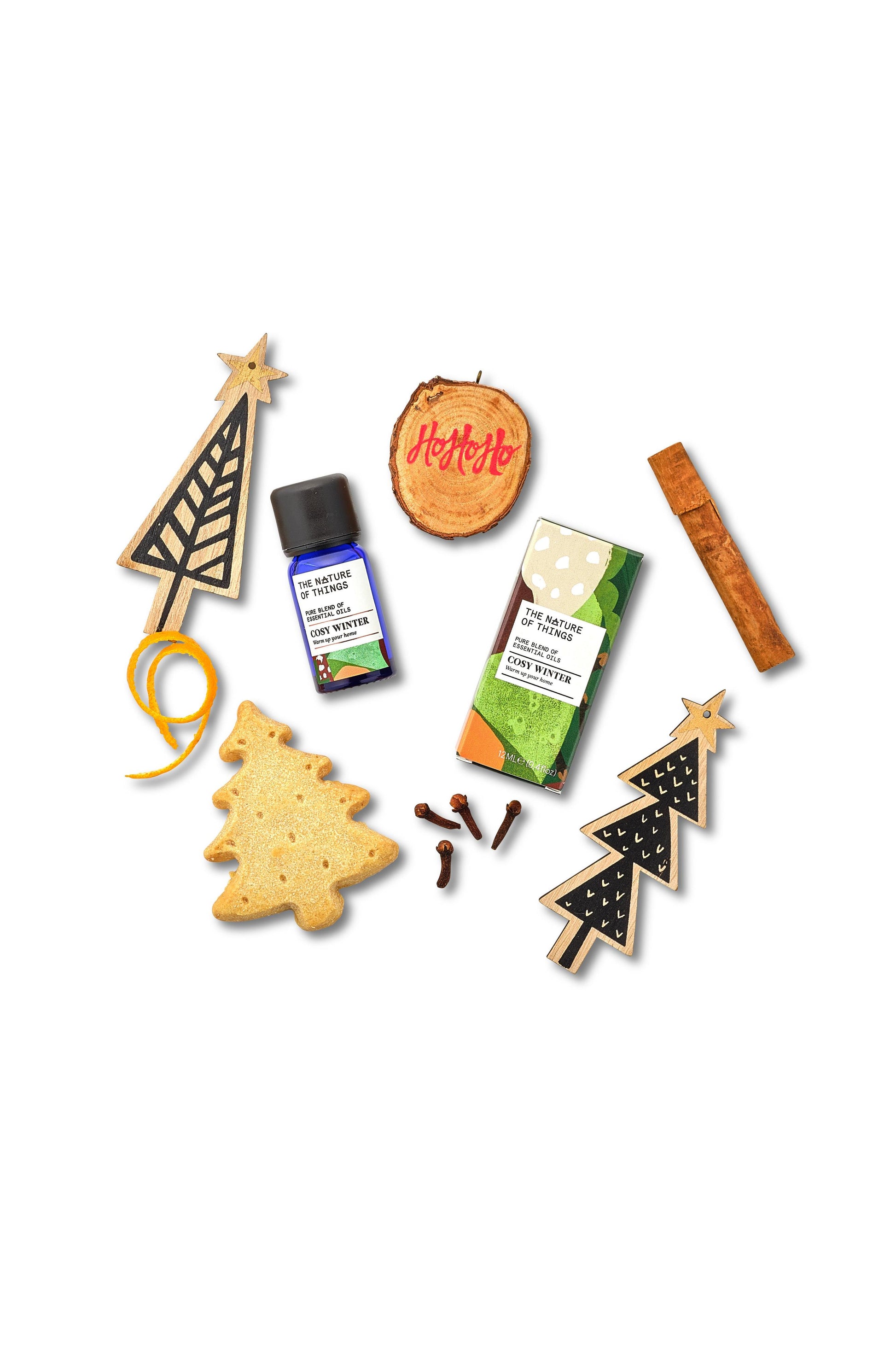 Collection of Christmas-themed items including tree-shaped cookies, a bottle, and packaging on a white background.