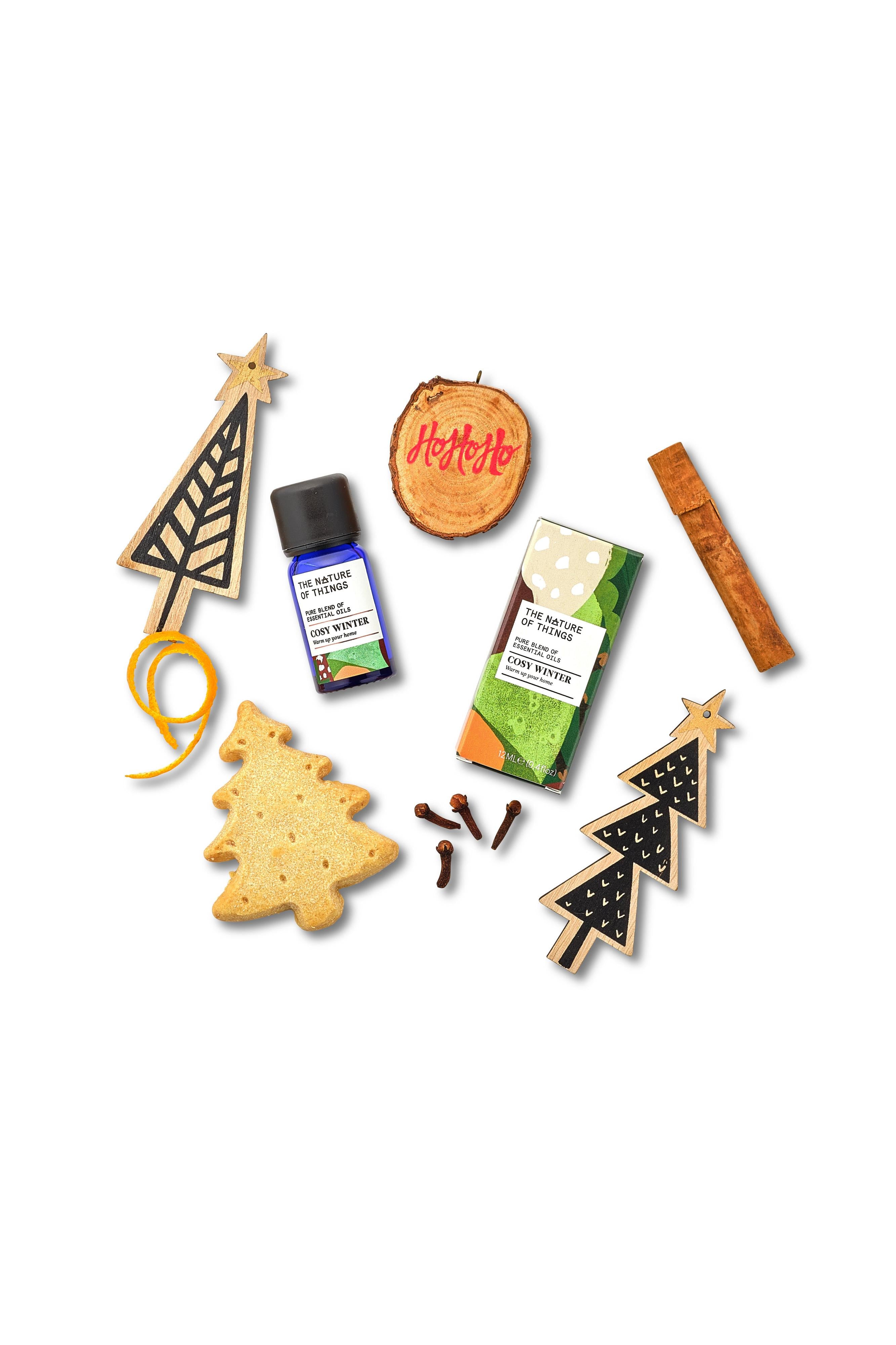 Collection of Christmas-themed items including tree-shaped cookies, a bottle, and packaging on a white background.