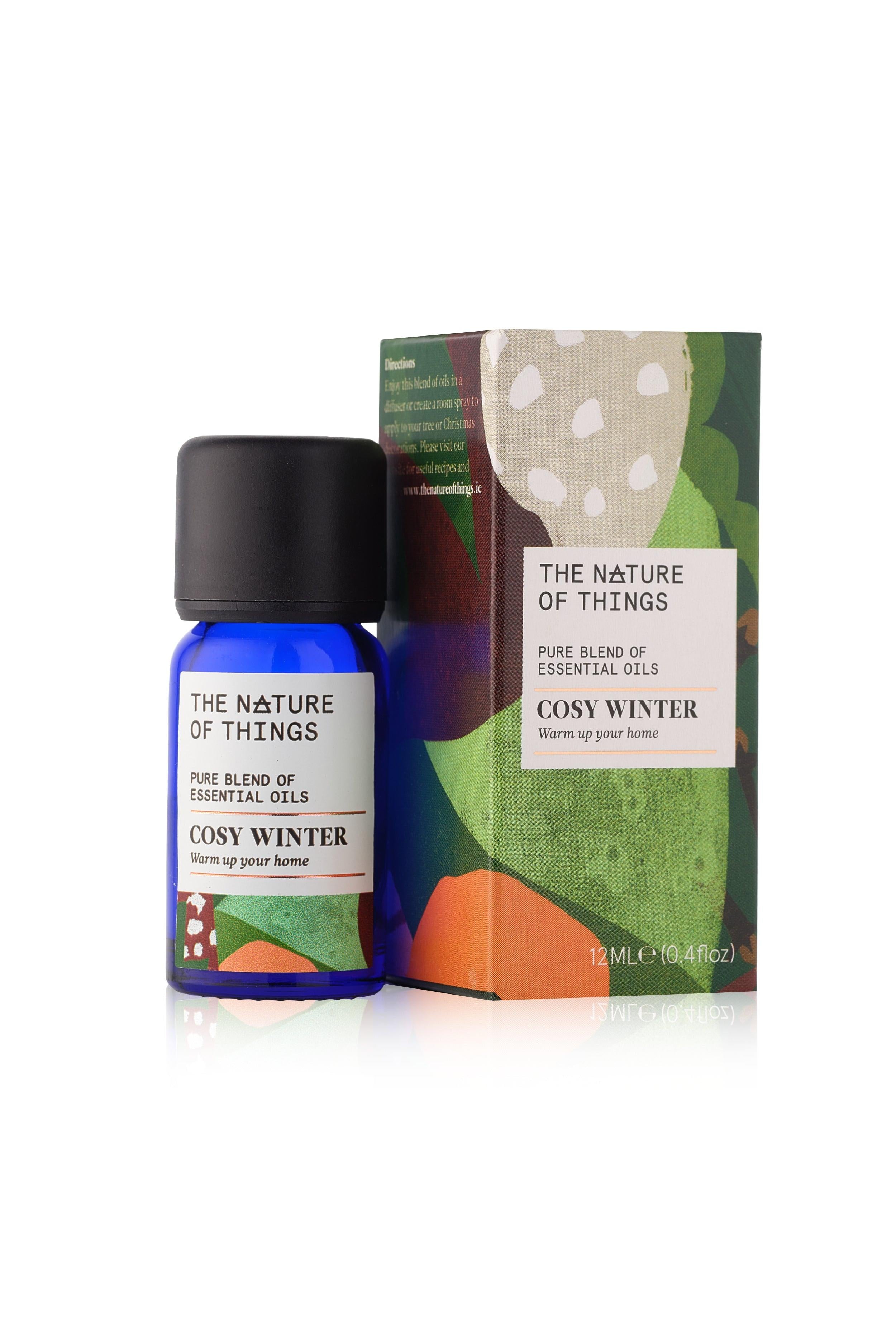 Bottle and box of 'The Nature of Things' Cosy Winter essential oil blend on a white background