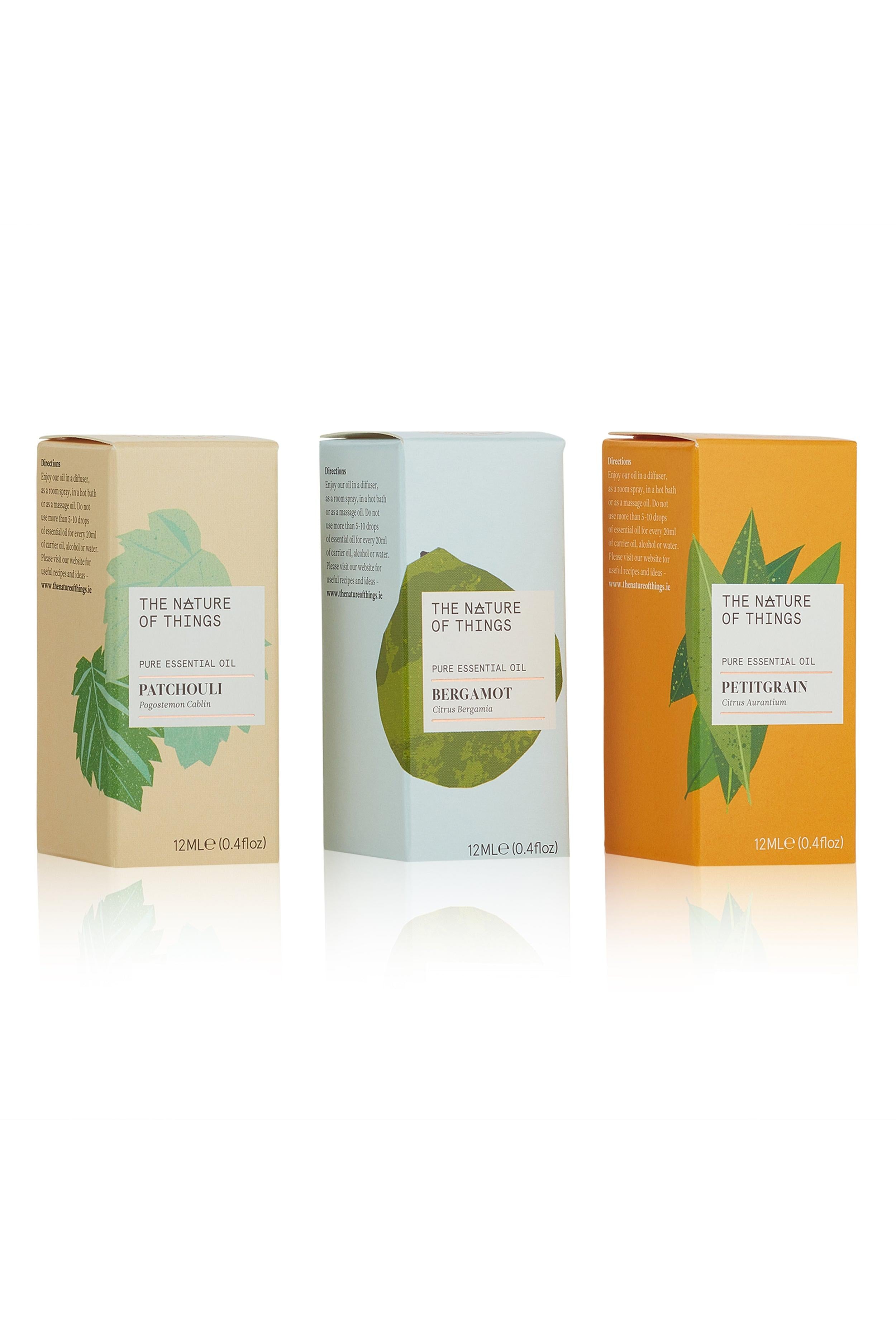 Three boxes of 'The Nature of Things' essential oils on a white background