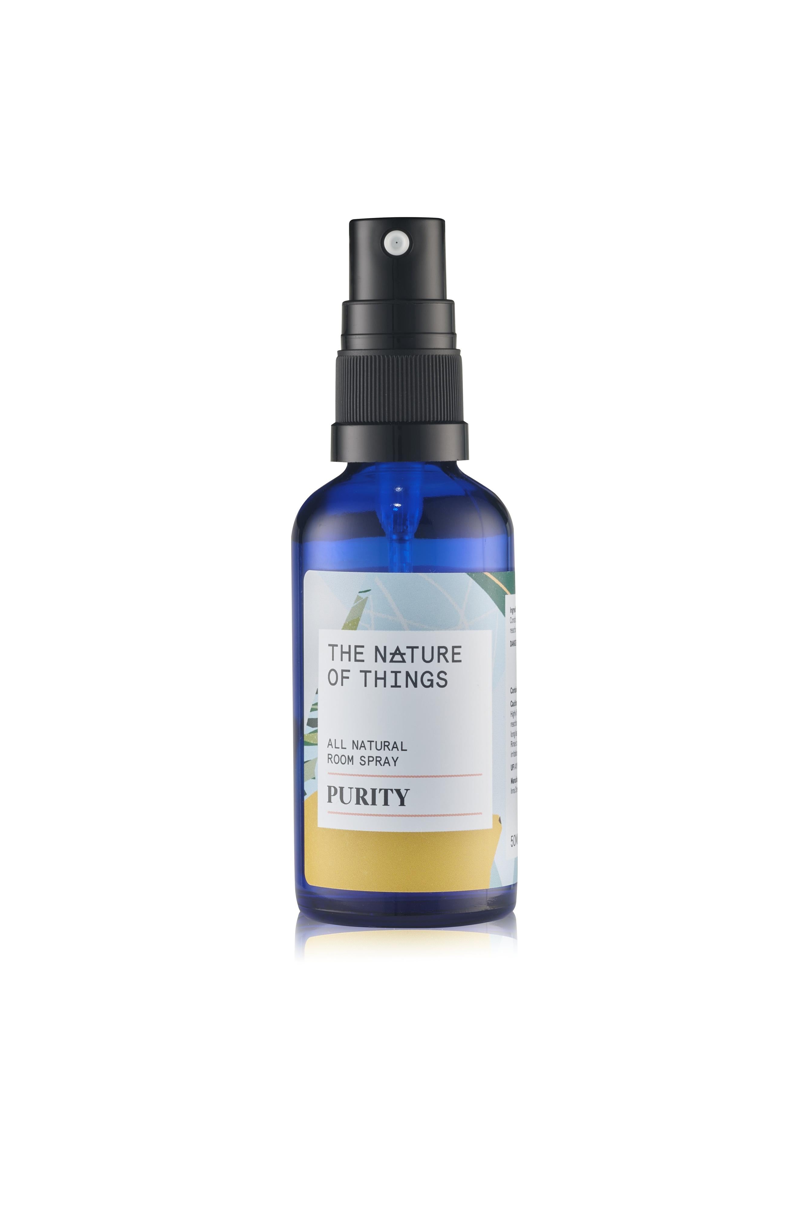 Blue spray bottle labeled 'The Nature of Things' on a white background