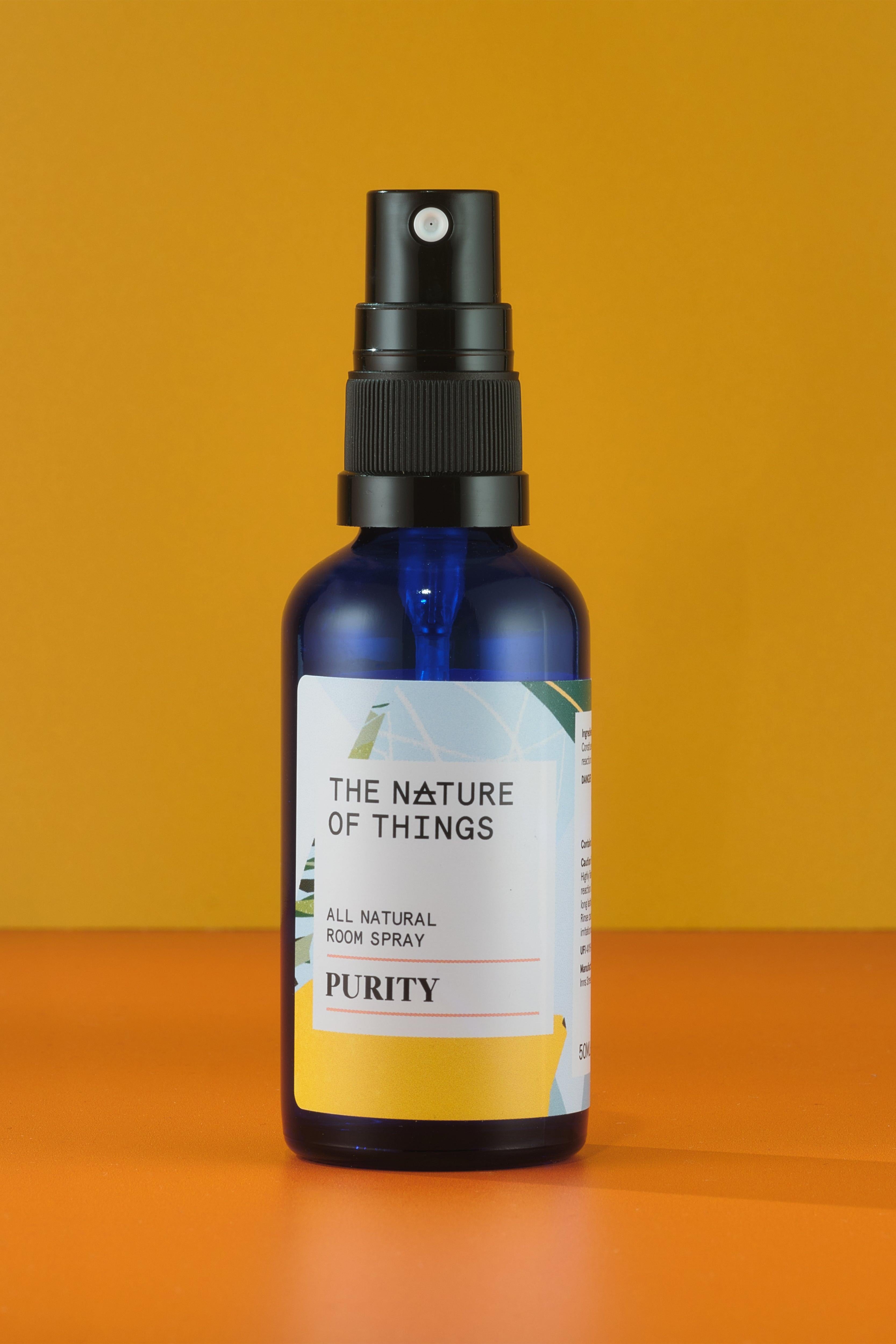 Bottle of 'The Nature of Things' purity spray on an orange background