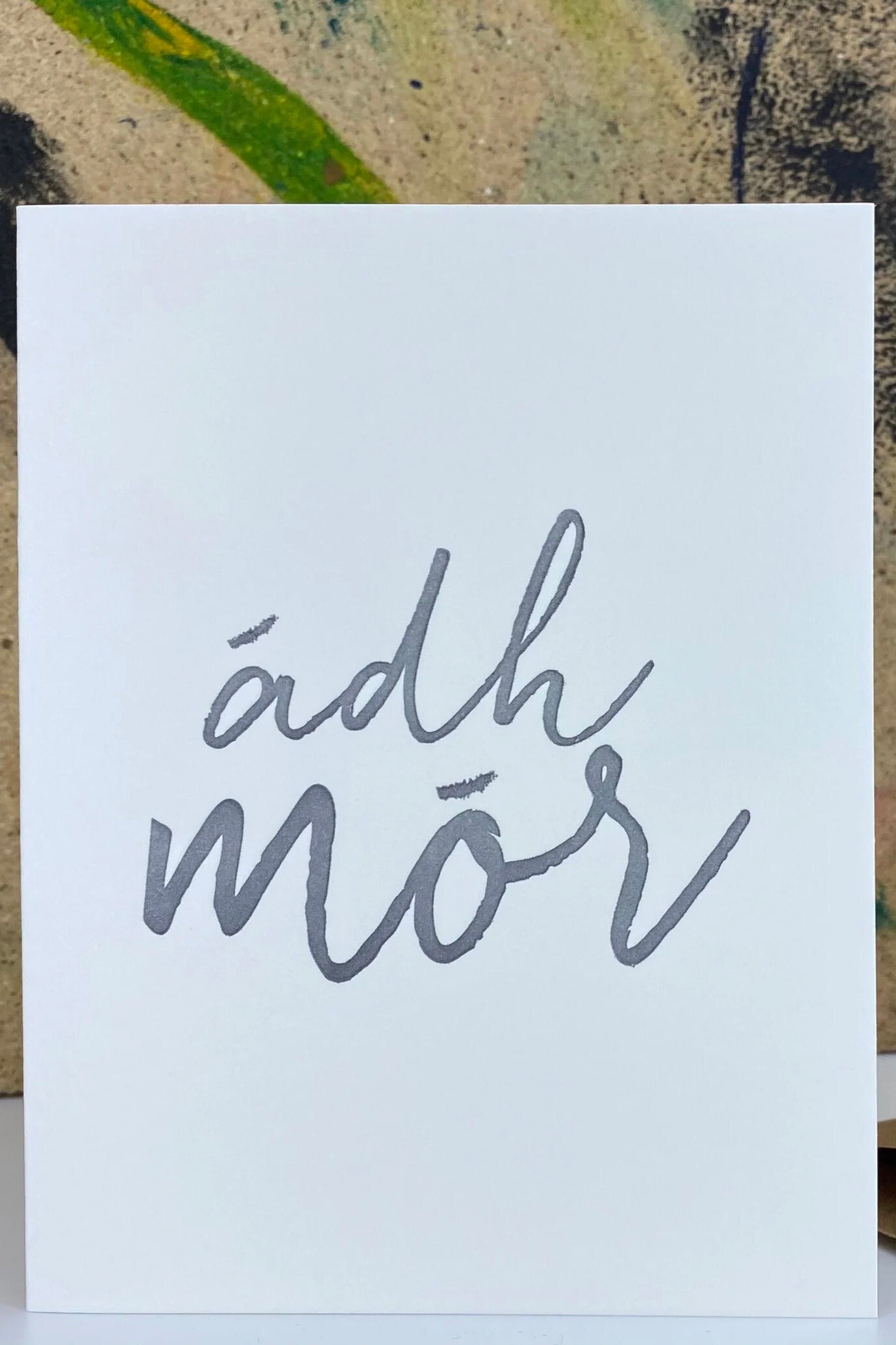 White card with 'adh mor' text on a textured background