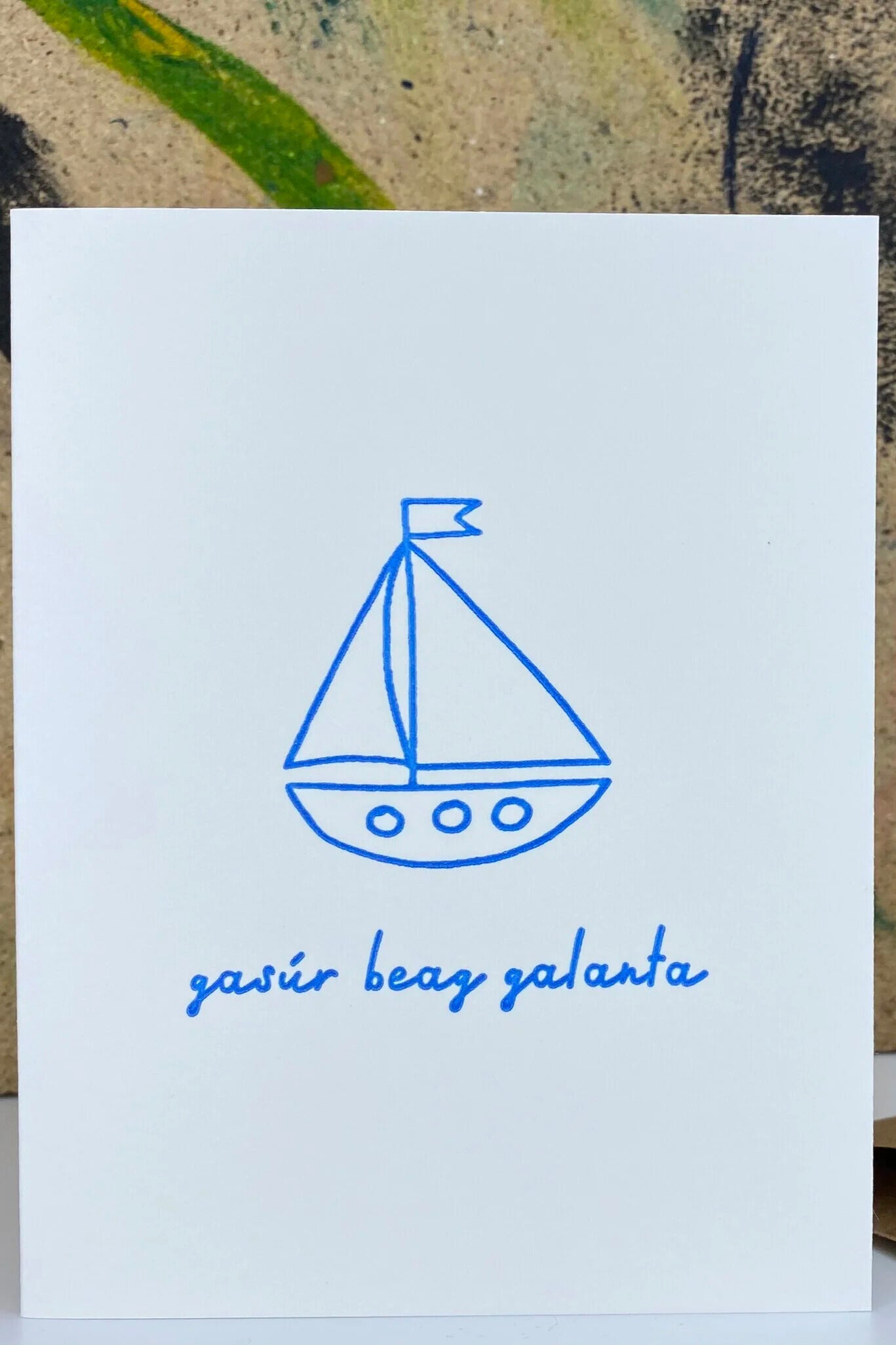Card with a blue sailboat illustration and text on a white background