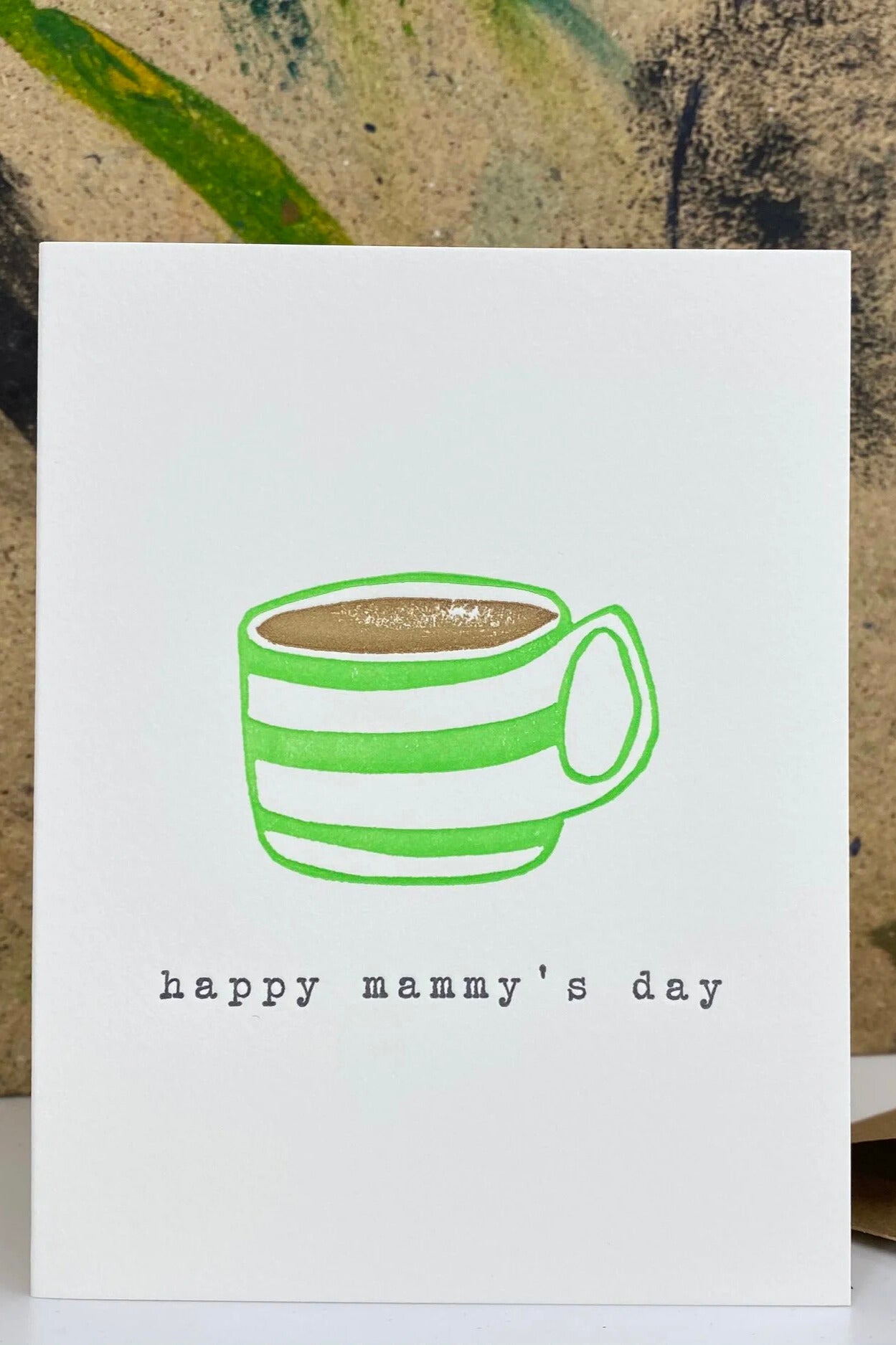 Card with a green striped coffee cup illustration and 'happy mammy's day' text on a textured background.