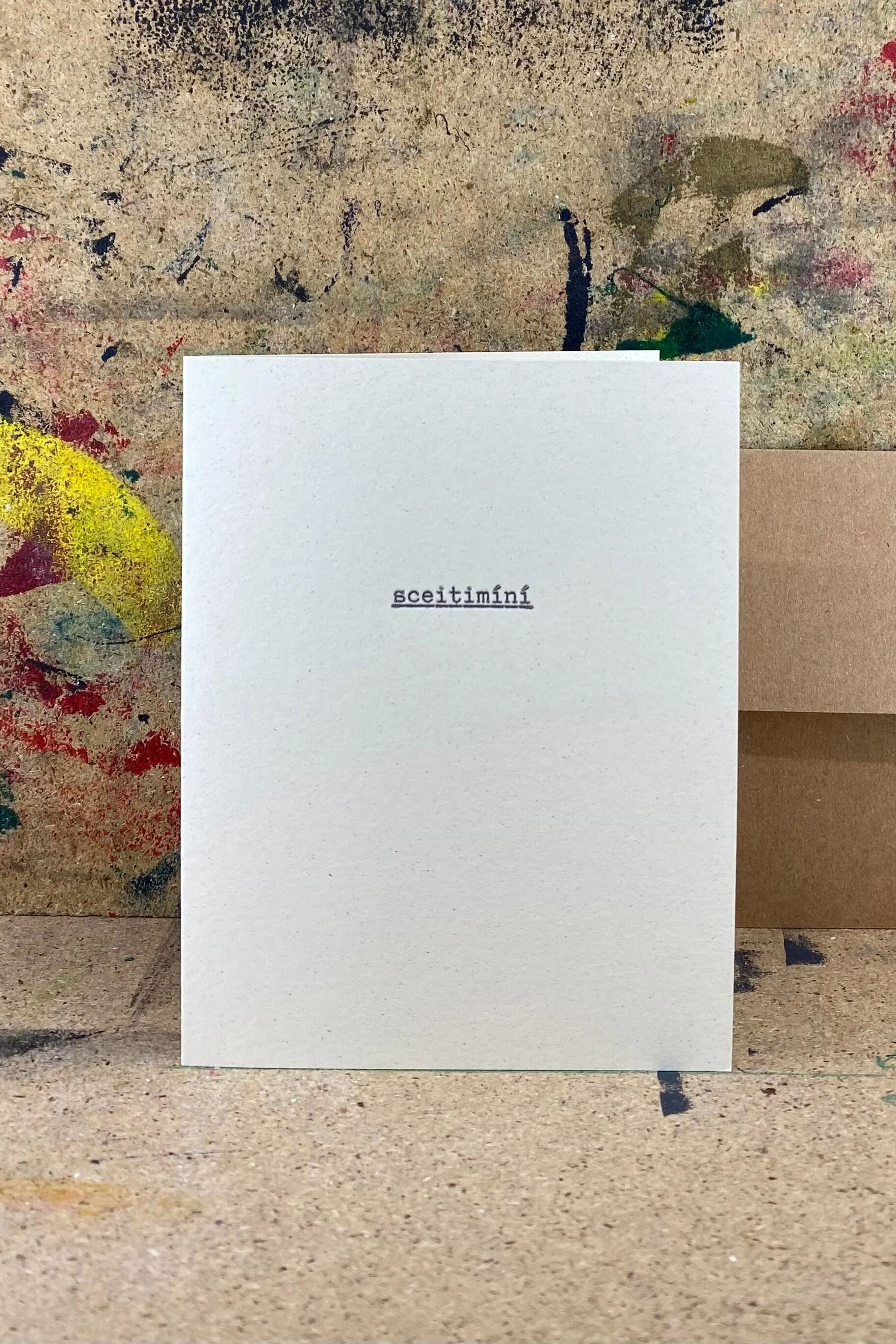 White card with text on a textured surface with abstract art