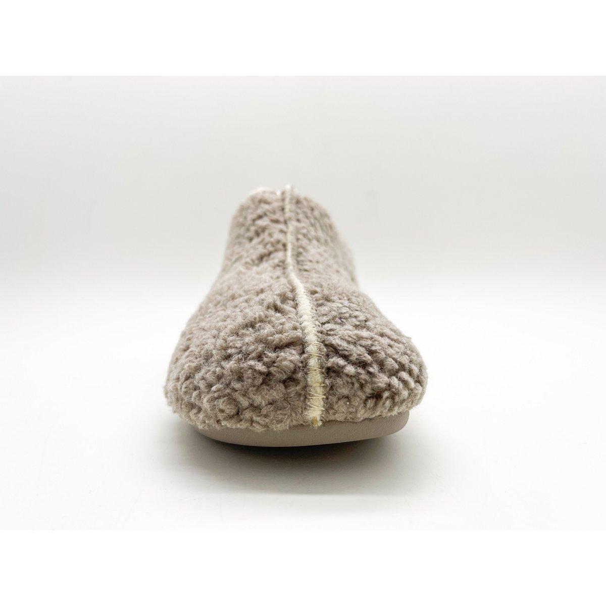 Beige slipper with fuzzy texture on a white background