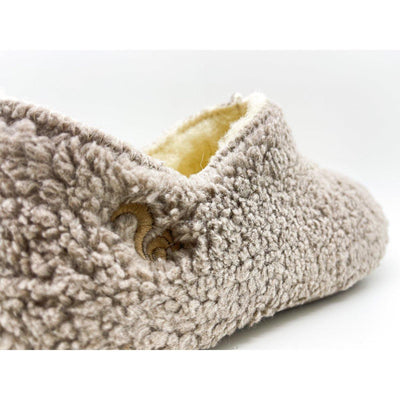 Beige sherpa slippers on a white background