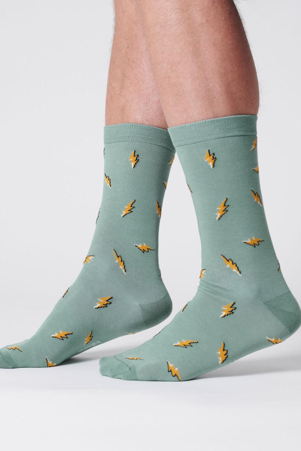 Mens lagoon green organic cotton socks with bold lightning bolt designs.