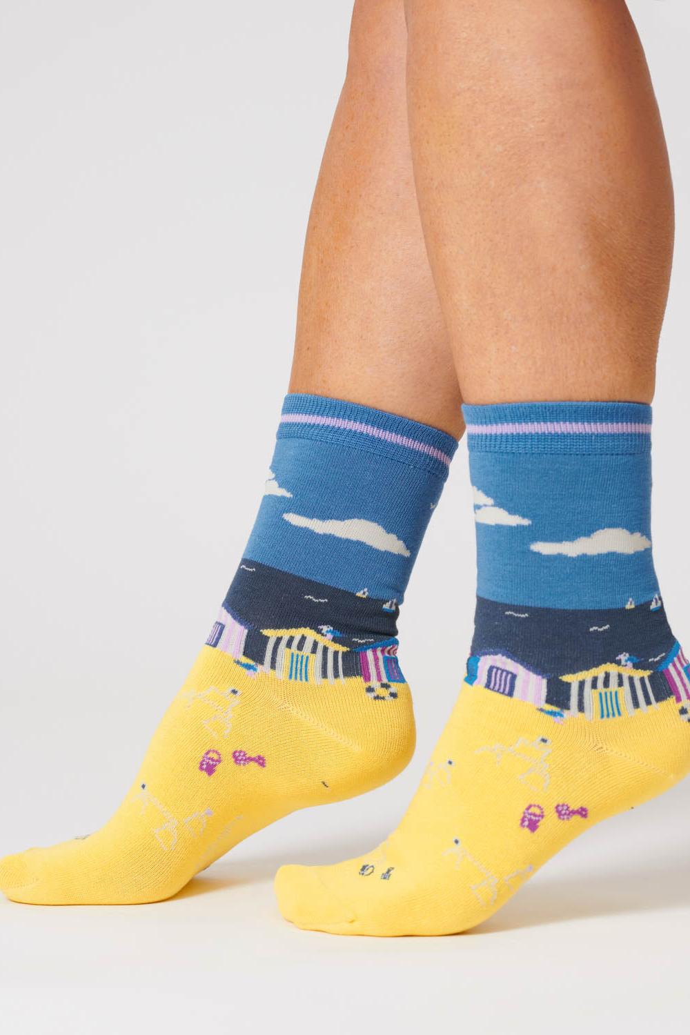 Sea blue organic cotton socks featuring a beach hut design in shades of blue and yellow.