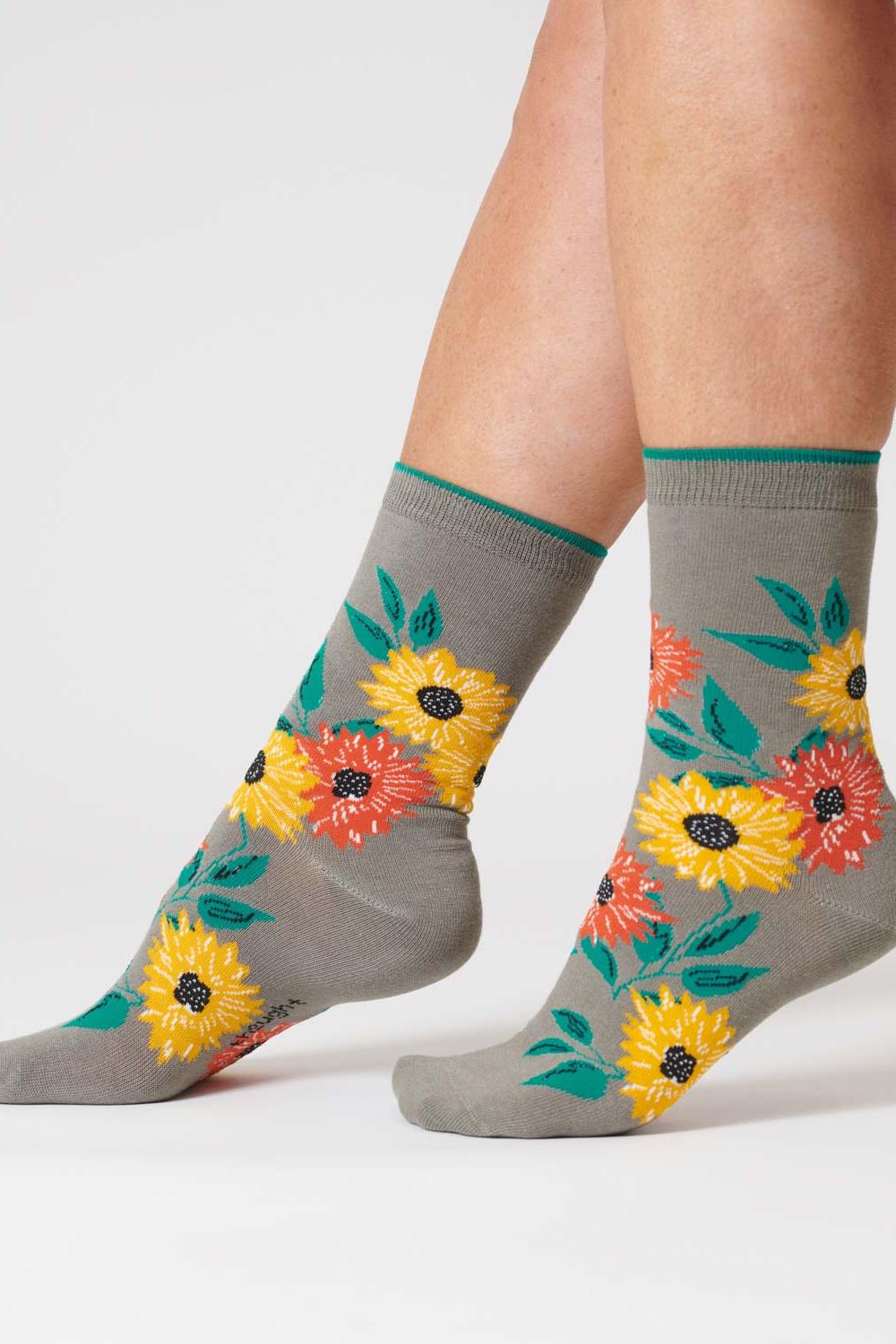 Olive green organic cotton socks adorned with a sunflower design.