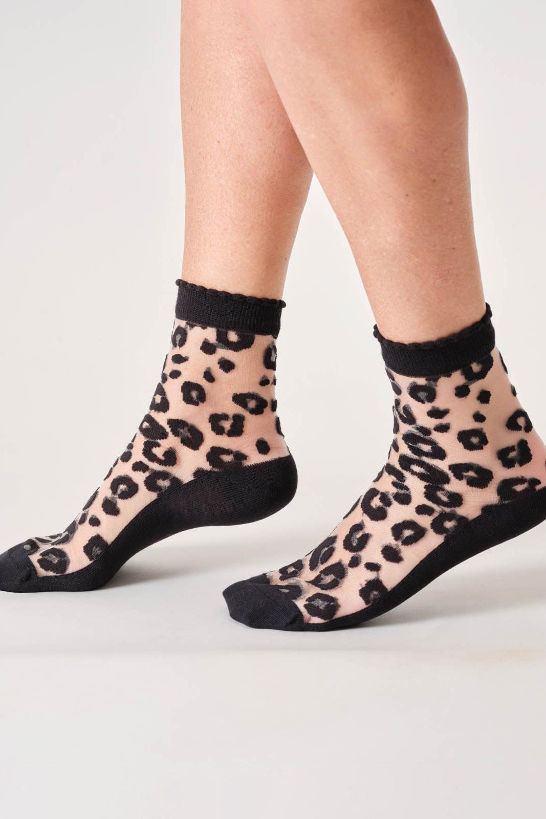 Sheer leopard print socks with black toes and cuffs on a white background