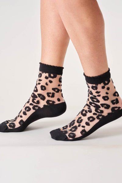 Sheer leopard print socks with black toes and cuffs on a white background