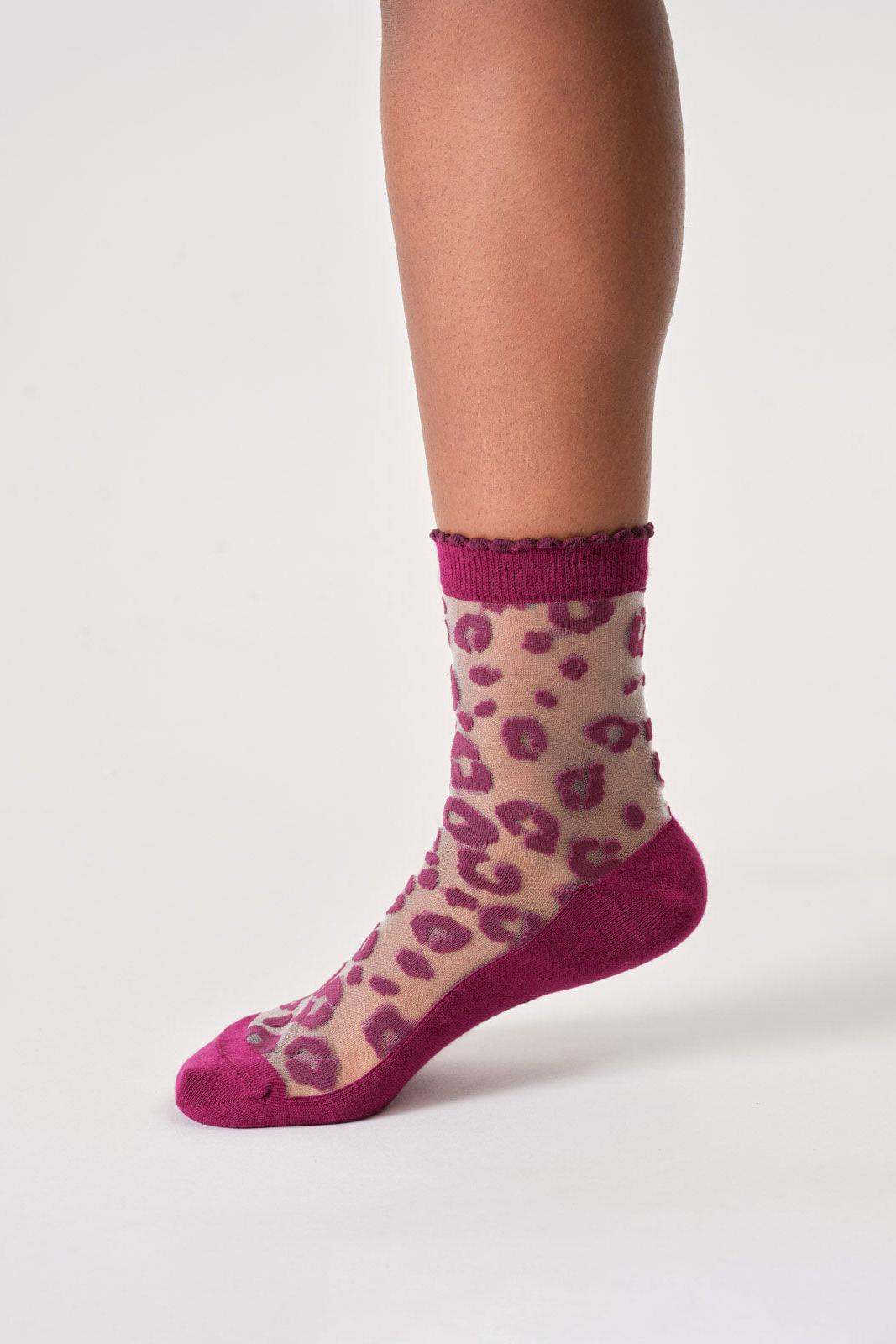 Sheer sock with purple leopard print on a white background