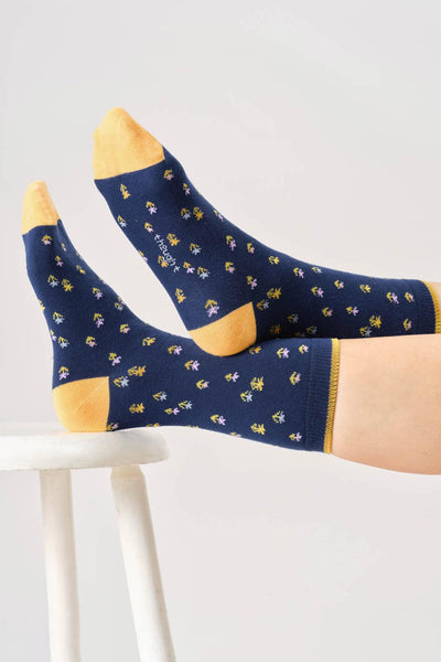Navy organic cotton socks with yellow accents and floral pattern on a white background