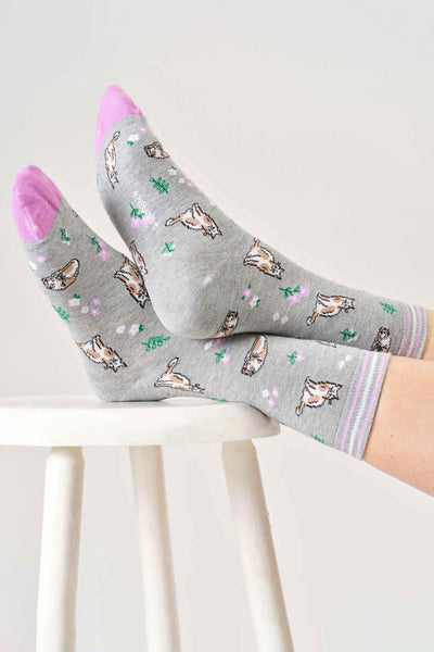 Gray organic cotton socks with cat pattern worn by a person on a white background