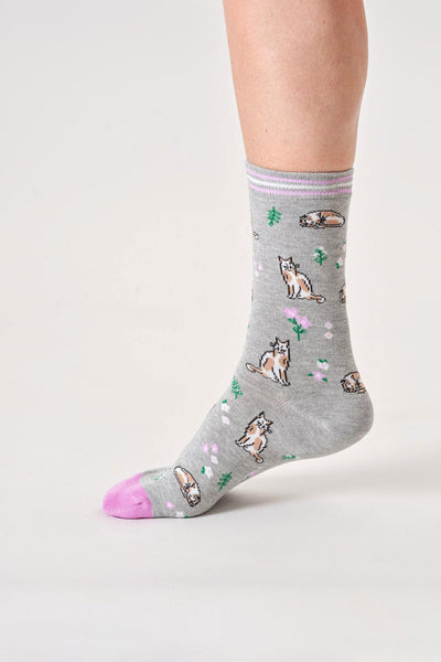 Gray organic cotton socks with cat pattern worn by a person on a white background
