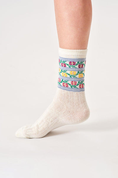 White wool socks with a colorful pattern on a white background