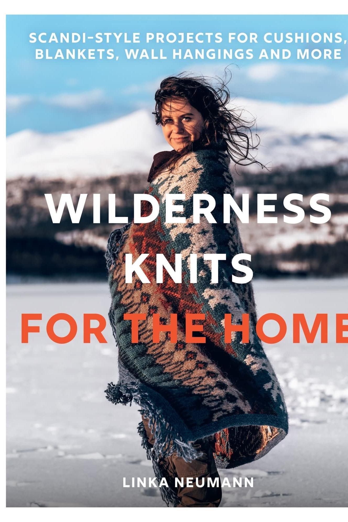 Book cover of 'Wilderness Knits for the Home' by Linka Neumann with a person wrapped in a knitted blanket in a snowy landscape.