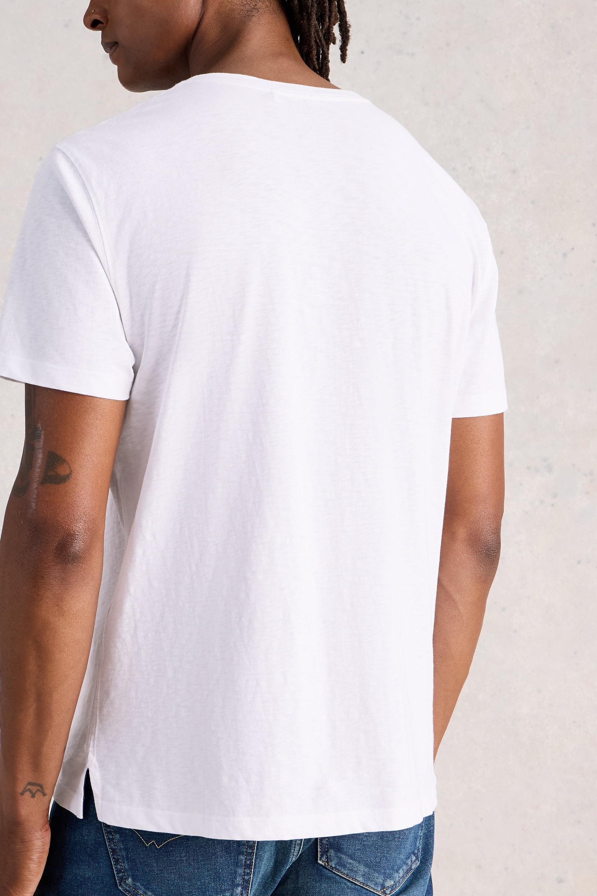 Model wearing a plain white t-shirt against a neutral background