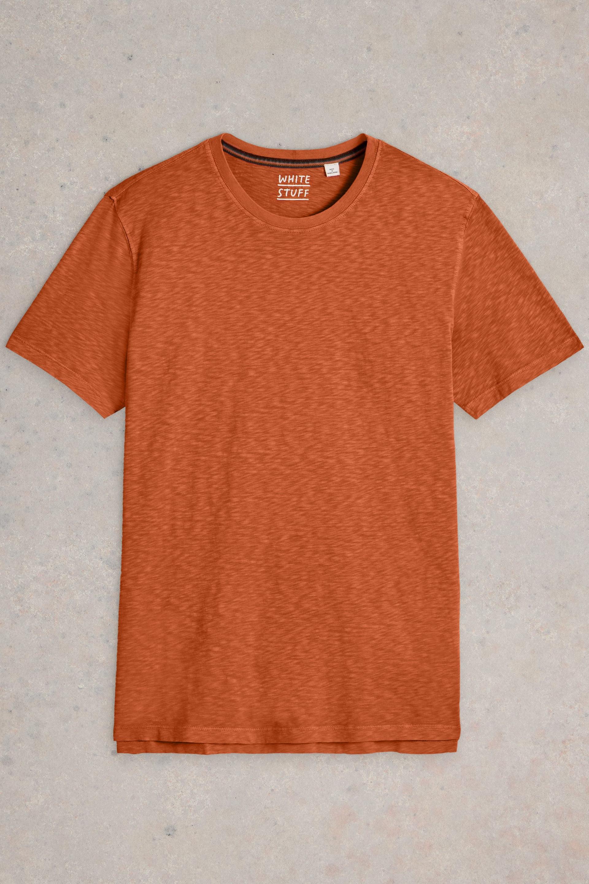 Orange cotton t-shirt laid flat on neutral background.