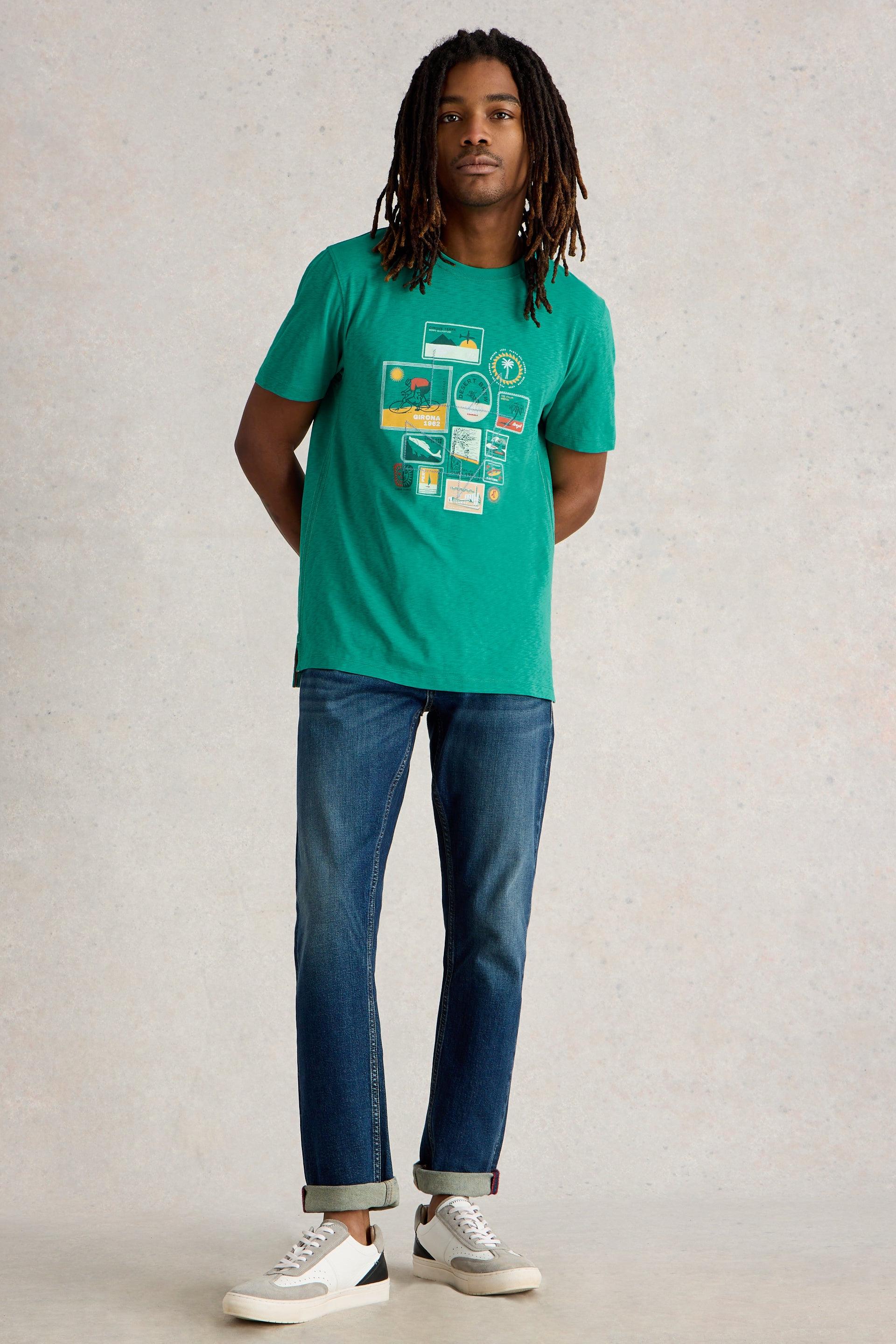 Model wearing teal cotton printed t-shirt paired with denim jeans and white trainers.
