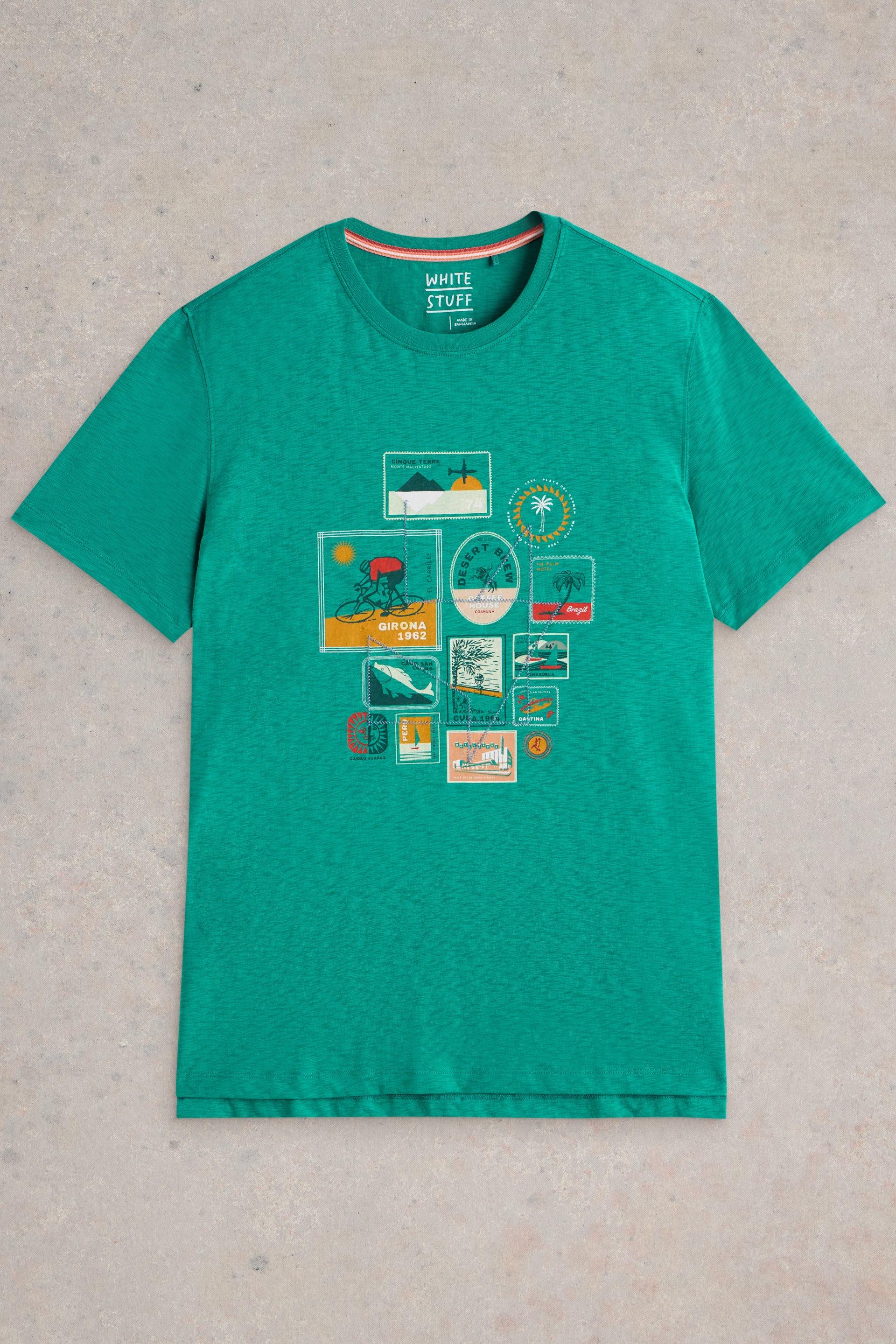 Teal travel printed t-shirt laid flat on neutral background.
