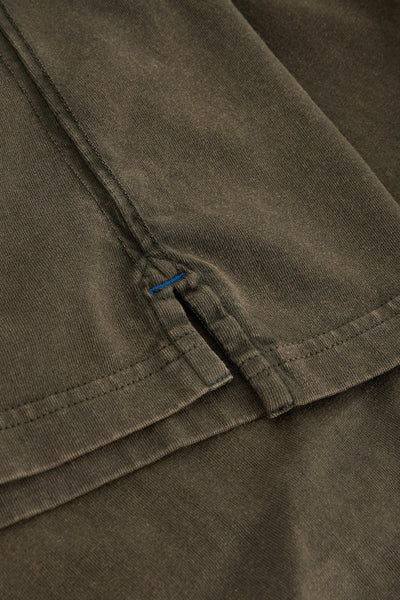 Close up of split length and blue stitching on long sleeve green organic cotton t-shirt