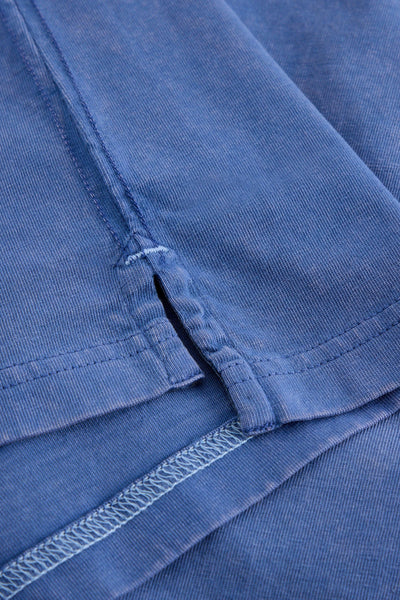 Close up of split hem on long sleeve blue organic cotton t-shirt 