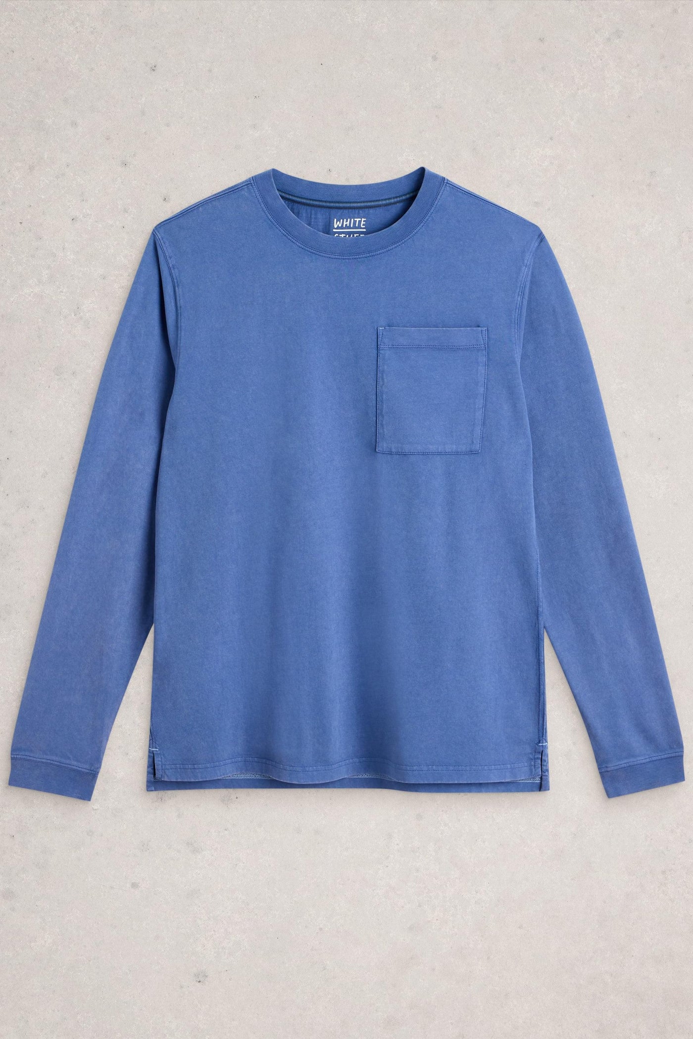 Flat lay of long sleeve blue organic cotton t-shirt on a neutral background
