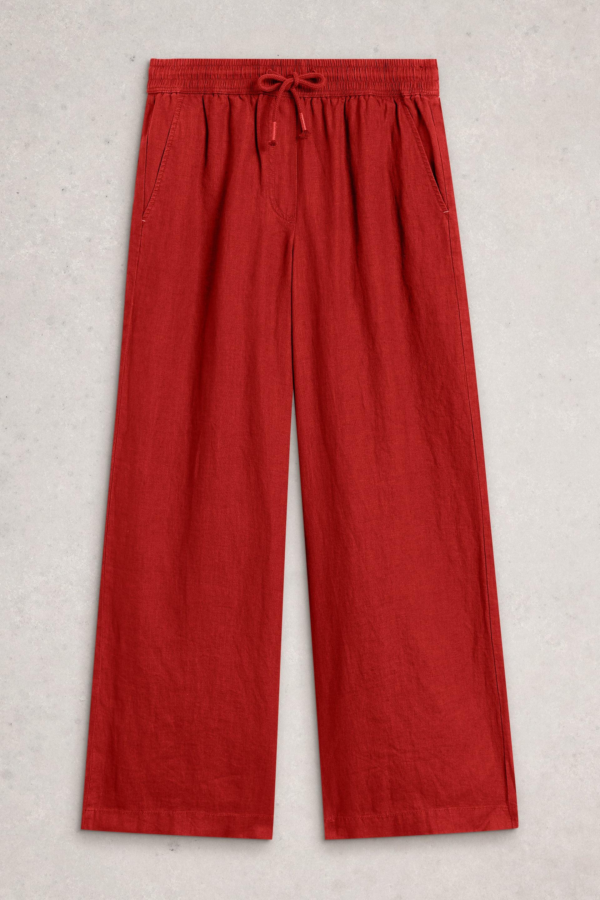 Red linen pants with a drawstring waist on a light gray background