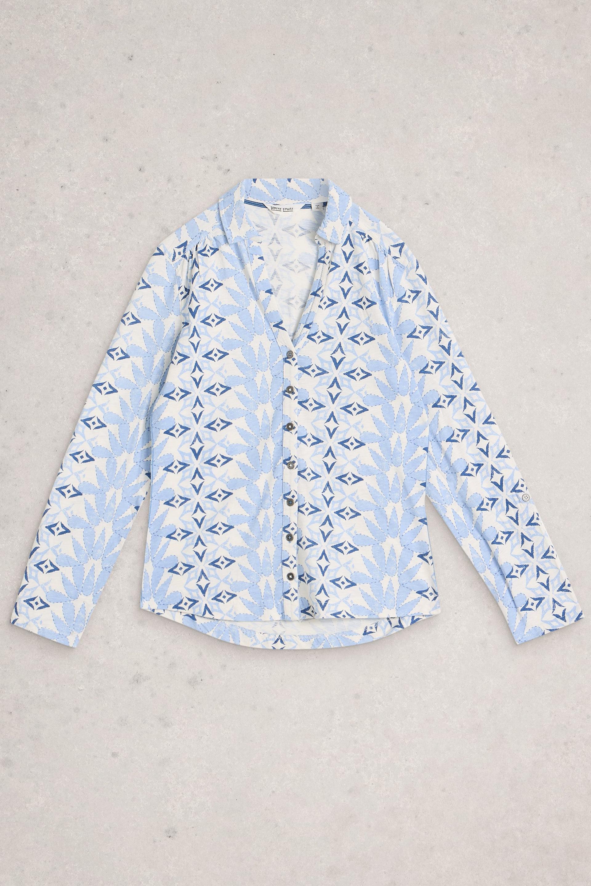 Light blue patterned shirt on a gray background