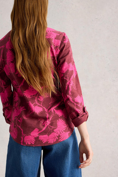 Back view of cotton jersey shirt with folded sleeves with button closure and a mid length