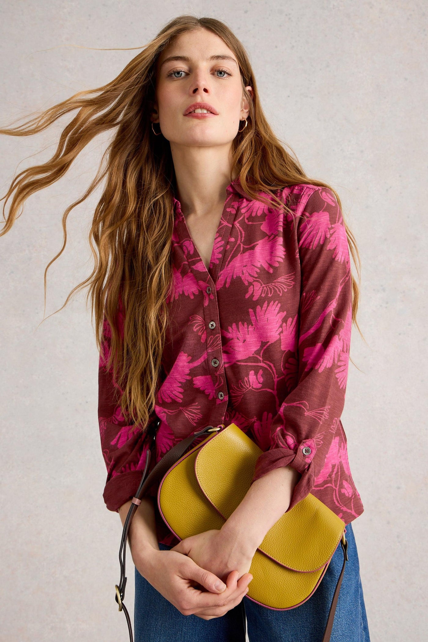 Model wearing plum cotton jersey shirt with pink flower print with collar, 3/4 sleeves, and classic fit