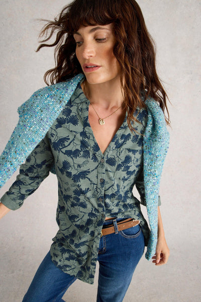 Model wearing green longline cotton tunic with blue floral print,with collar, long sleeves, and classic fit