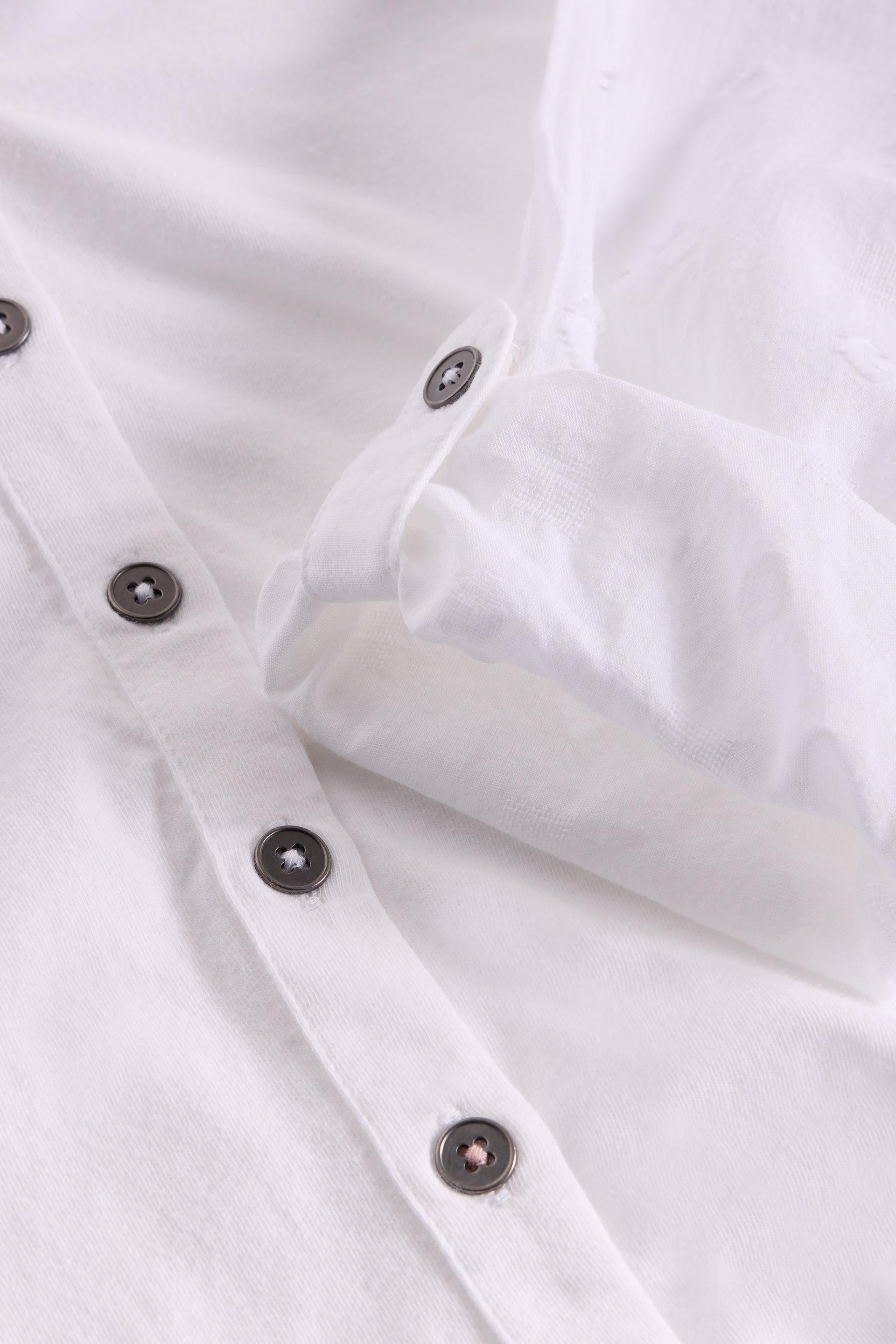 Close up of buttons on organic cotton white shirt.