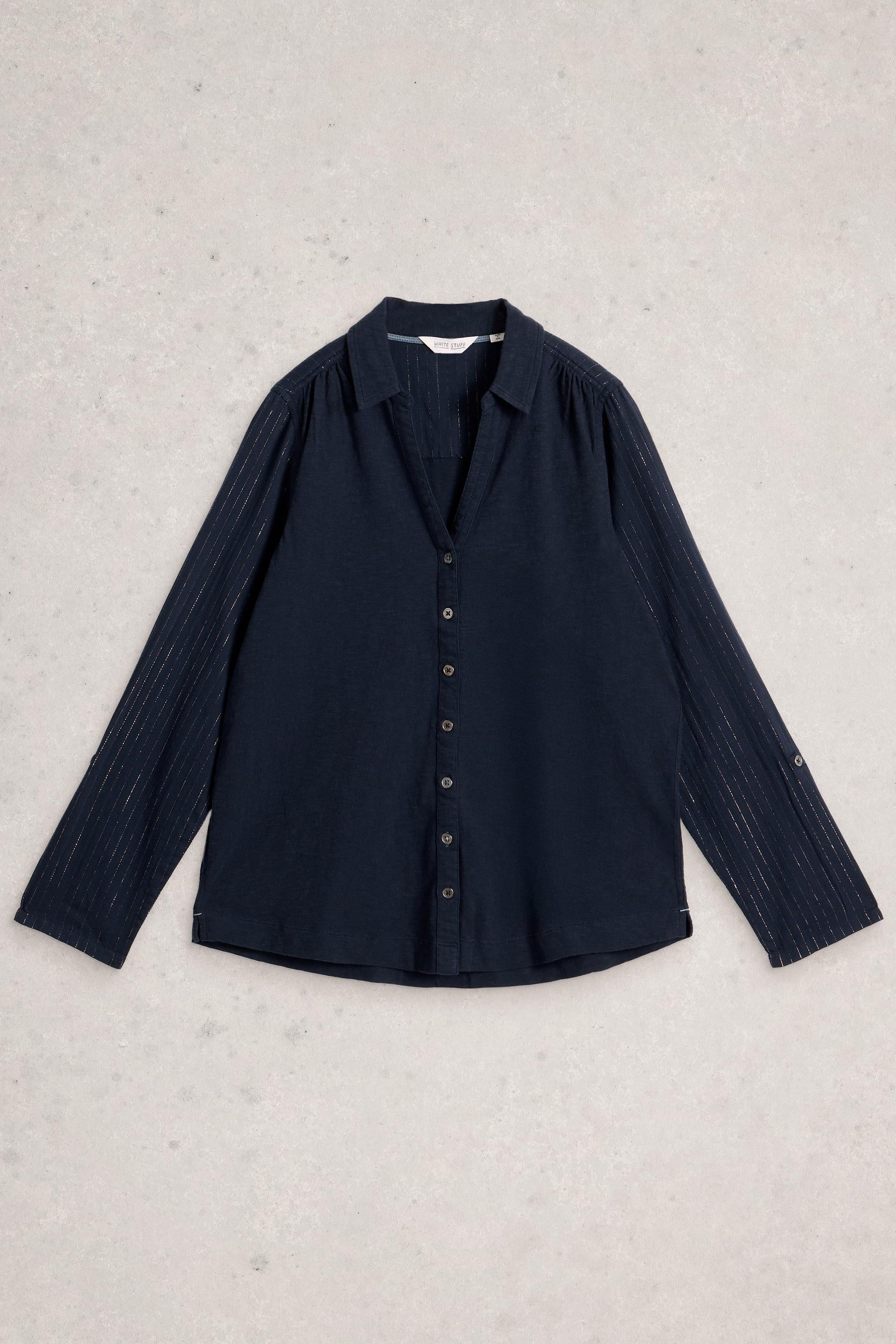 Navy organic cotton shirt on a light gray textured background