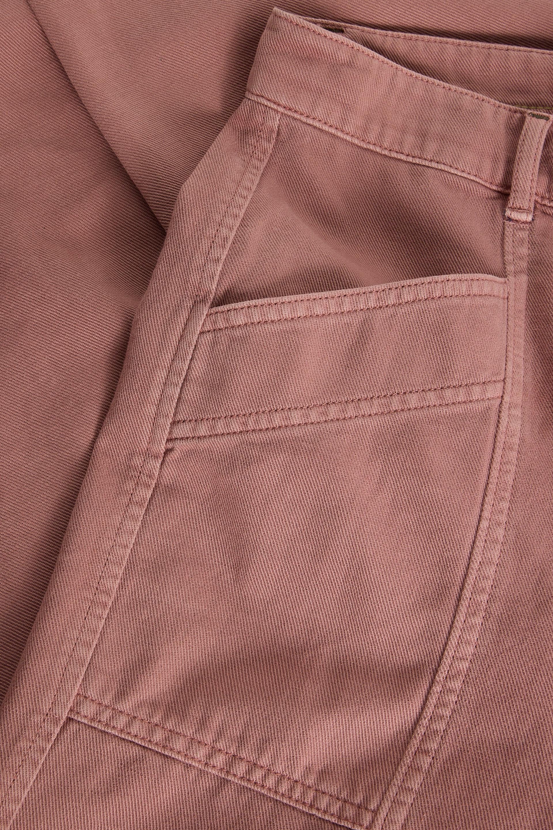 Close-up of a pinkish-brown fabric with a pocket detail