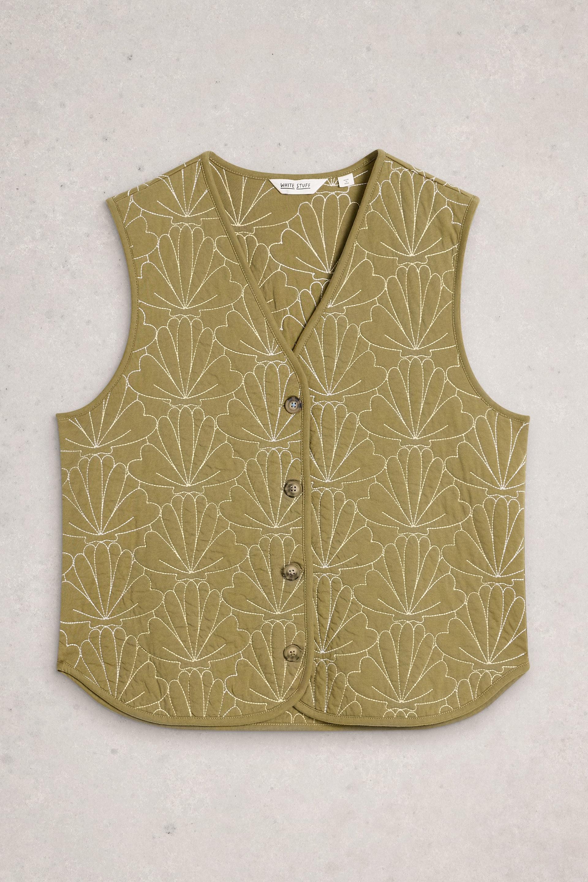 Green vest with white shell pattern on a light gray background