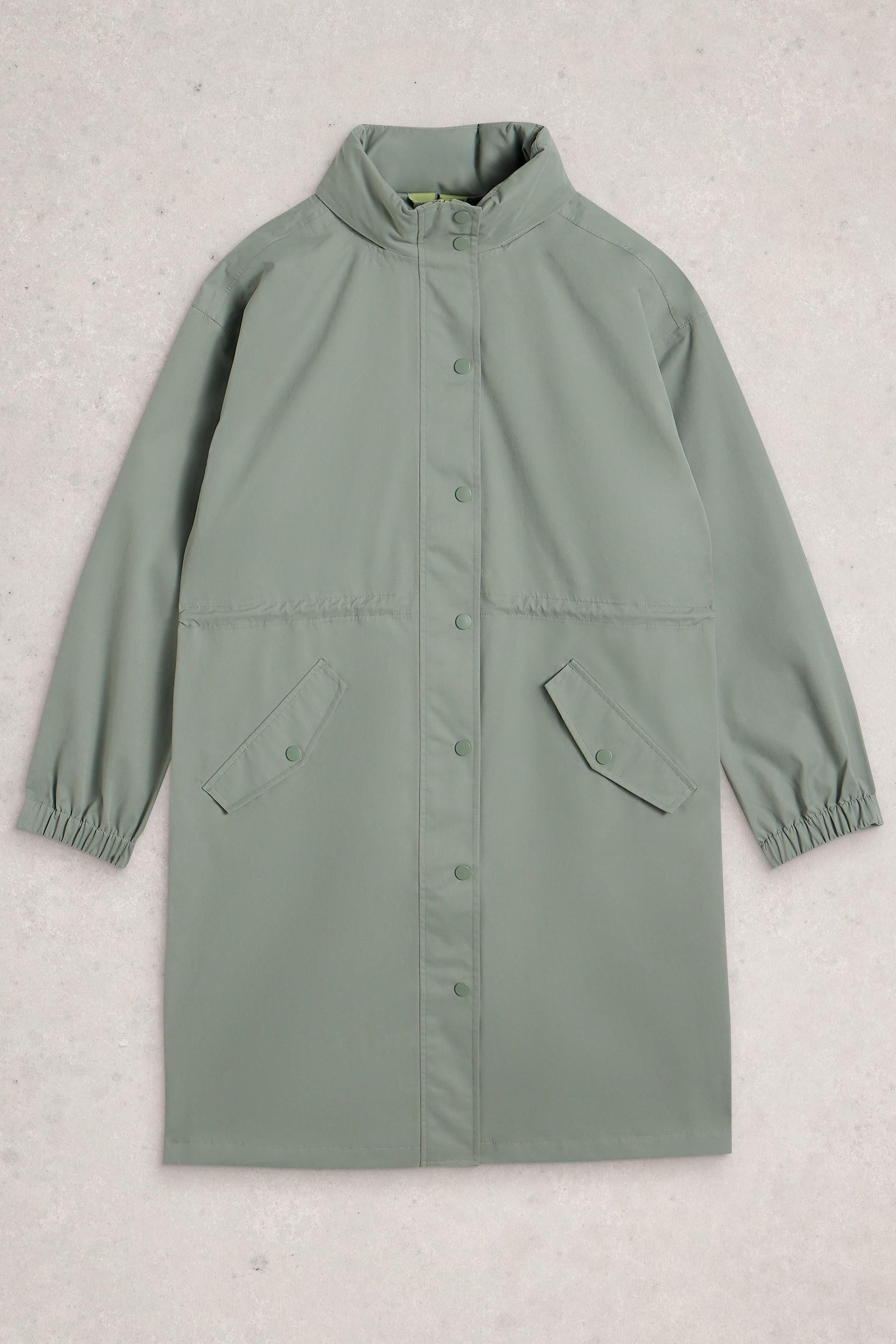 Green waterproof raincoat on a light gray background