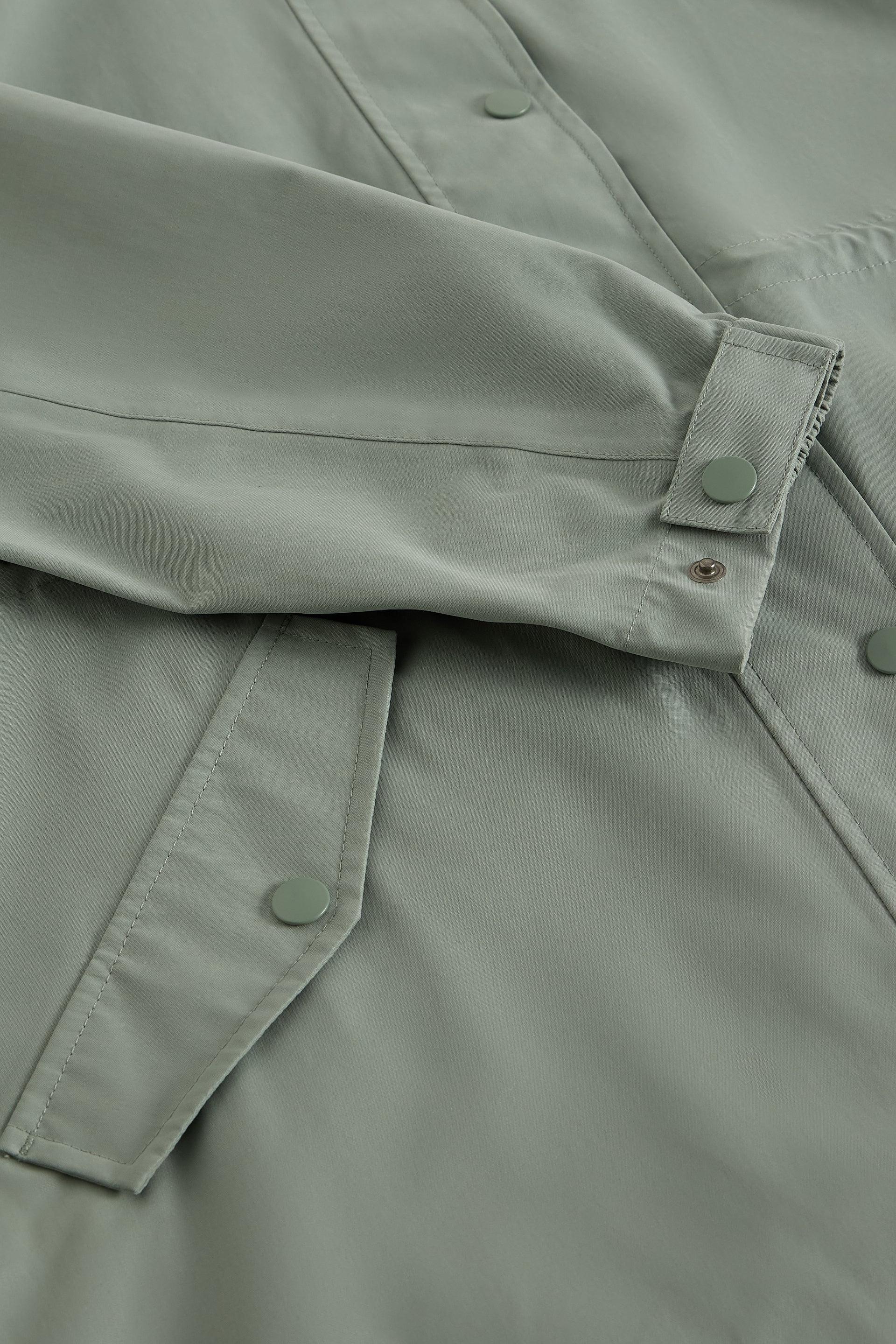 Close-up of a green jacket with button details
