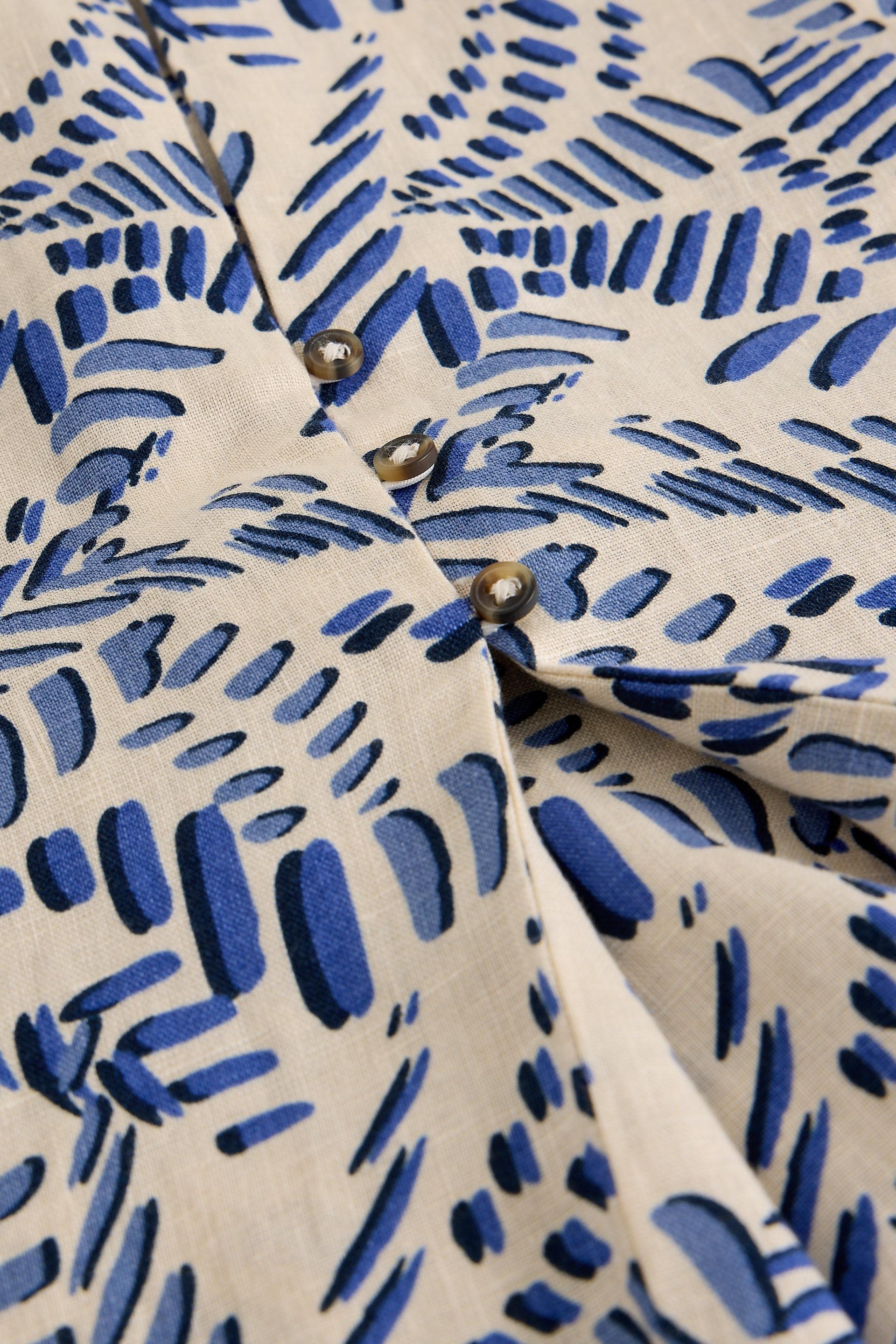 Close-up of a shirt with blue abstract pattern on beige background