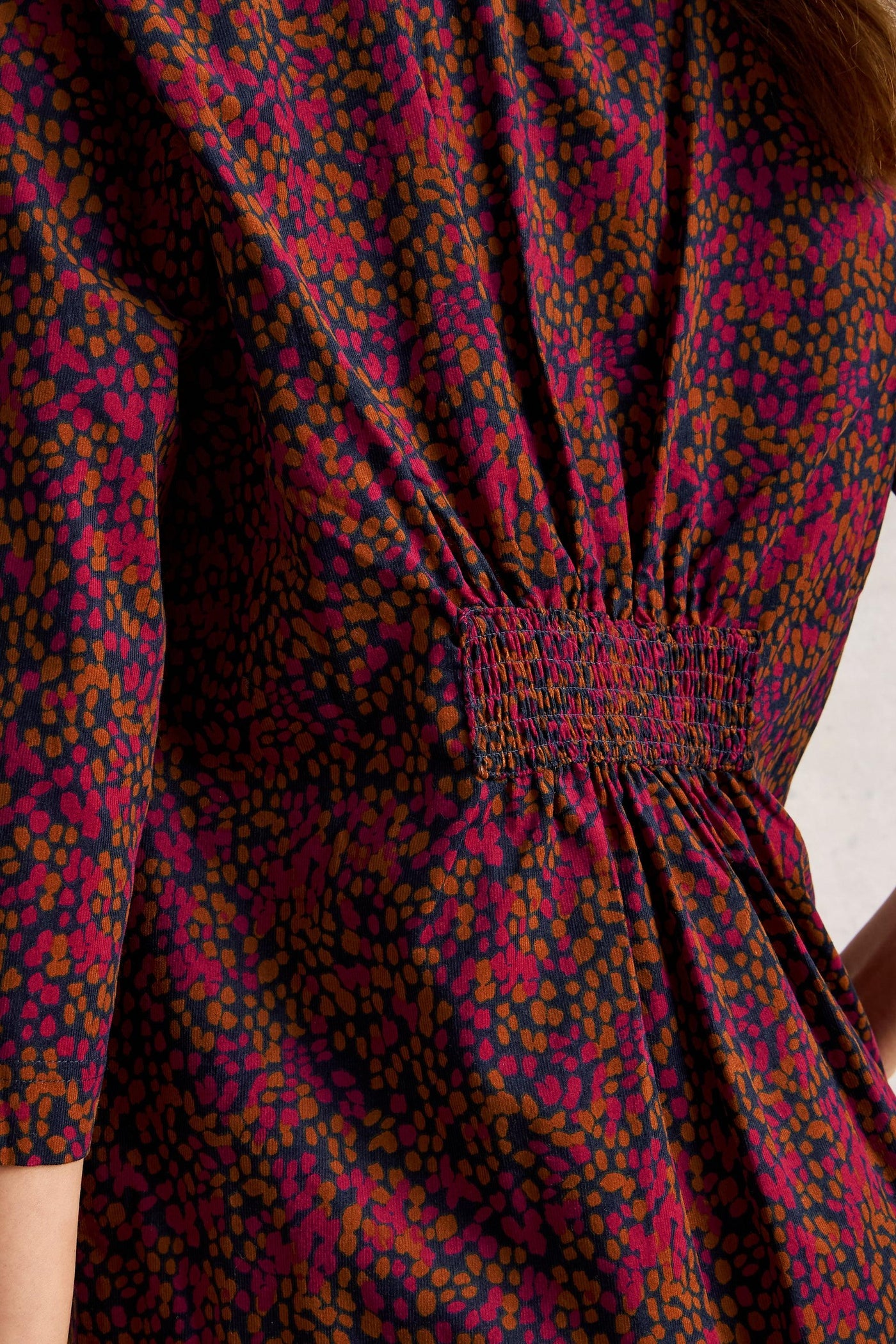 Close-up of ruched detail on pink organic cotton tunic